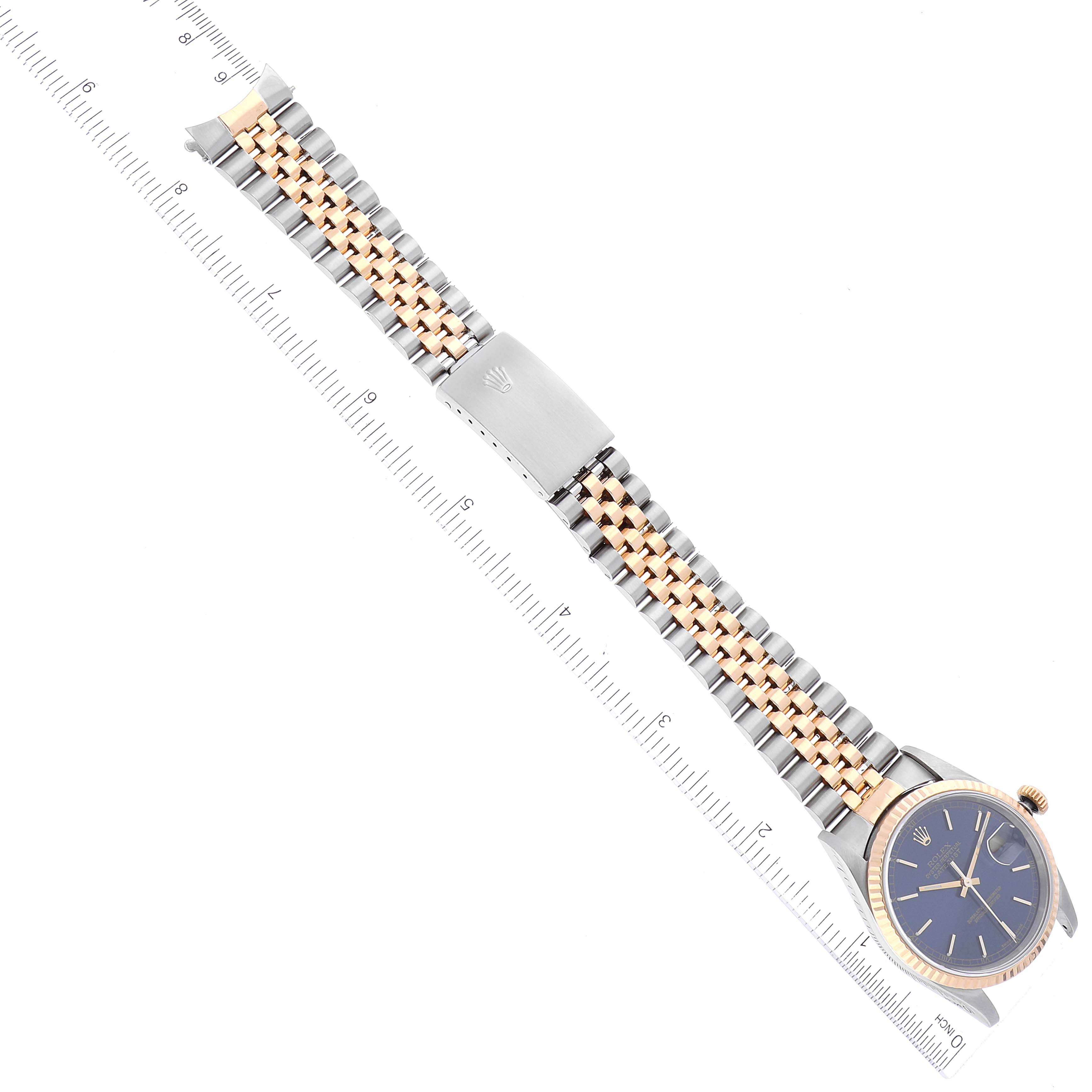 The Rolex Datejust 16233 Men's Steel and Gold (two tone) Blue Dial 16233 Men's Steel and Gold (two tone) Blue Dial model watch is shown from a top-down angle, highlighting its bracelet and face.