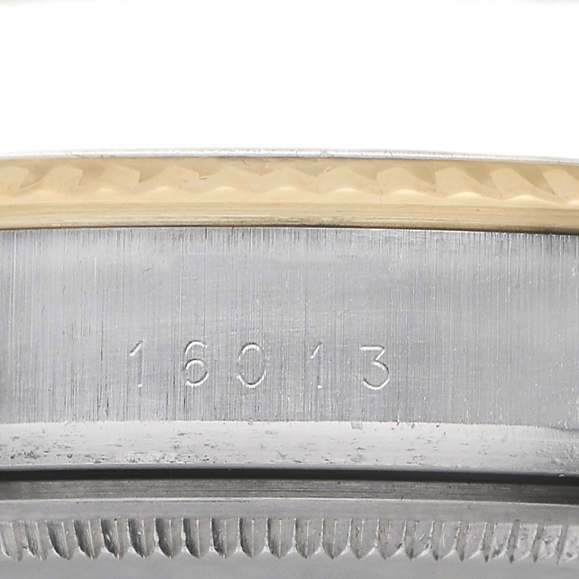 The image shows a close-up of the side of a Rolex Datejust 16013 Men's Steel and Gold (two tone) Black Dial, highlighting the bezel and engraved reference number.