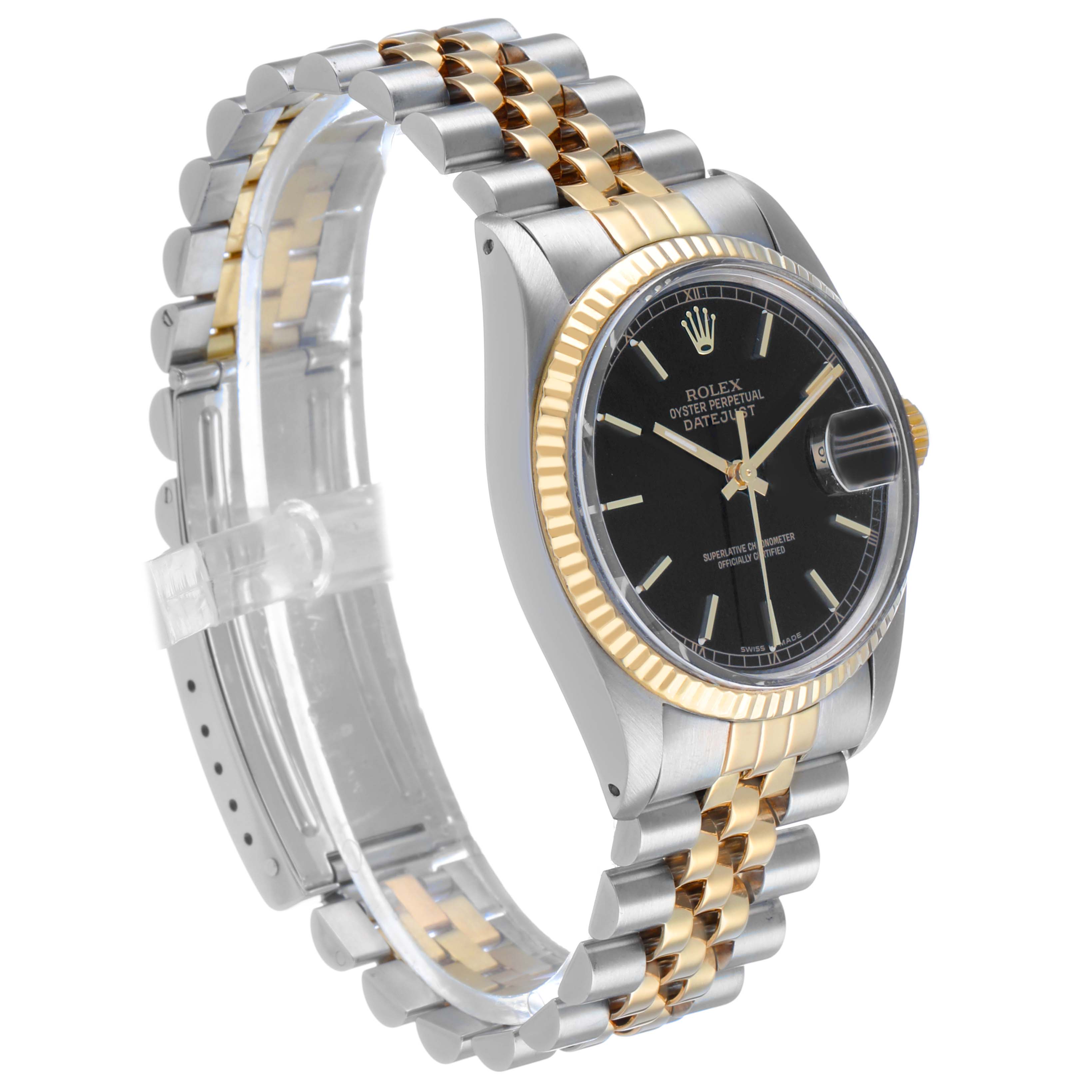 The Rolex Datejust 16013 Men's Steel and Gold (two tone) Black Dial watch is shown at a slight angle, highlighting the black dial, fluted bezel, and two-tone Jubilee bracelet.