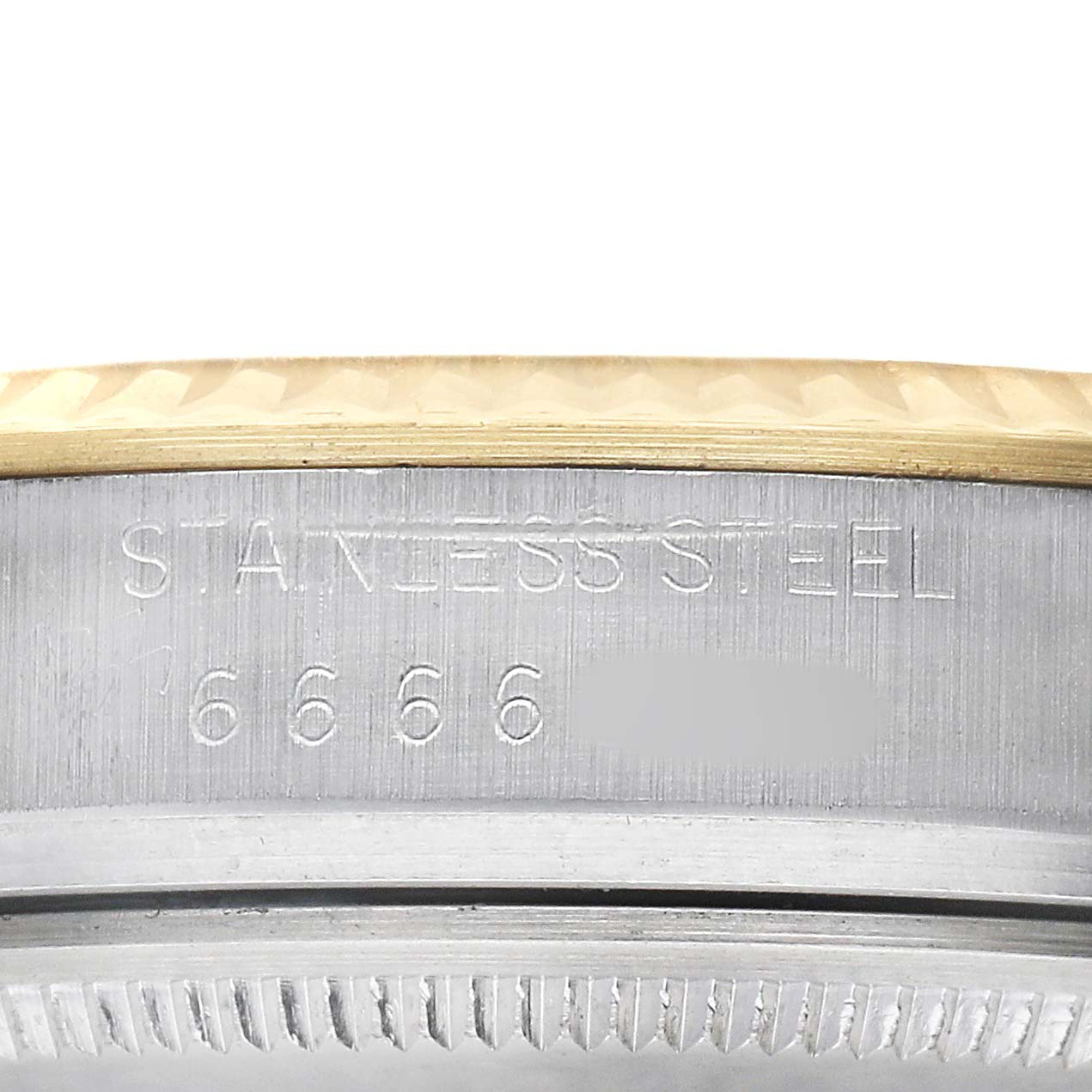 The image shows a close-up of the side of a Rolex Datejust 16013 Men's Steel and Gold (two tone) Black Dial watch, revealing the "STAINLESS STEEL" engraving and part of the bezel.