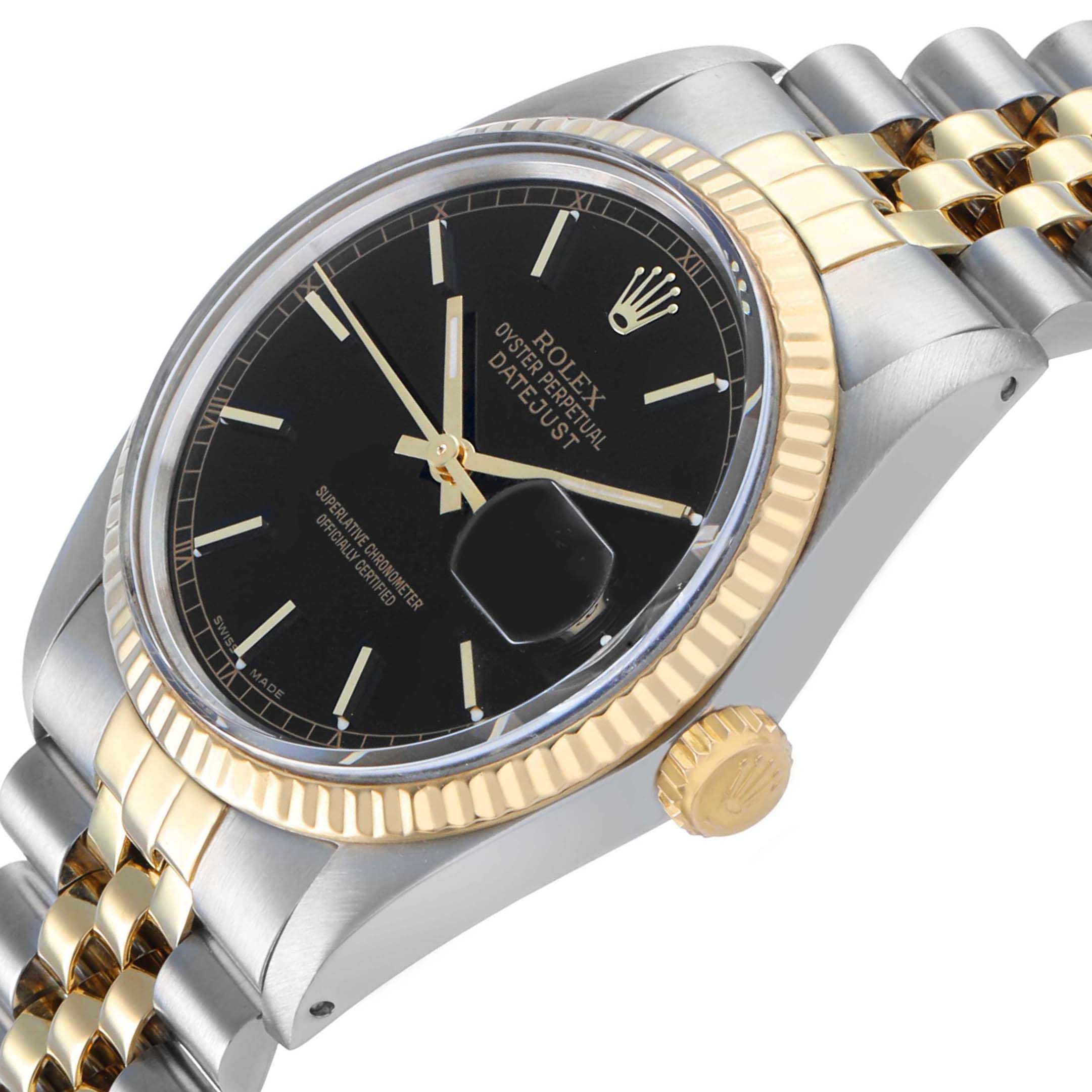 The Rolex Datejust 16013 Men's Steel and Gold (two tone) Black Dial watch is shown at an angled view, displaying its black dial, gold fluted bezel, and two-tone bracelet.