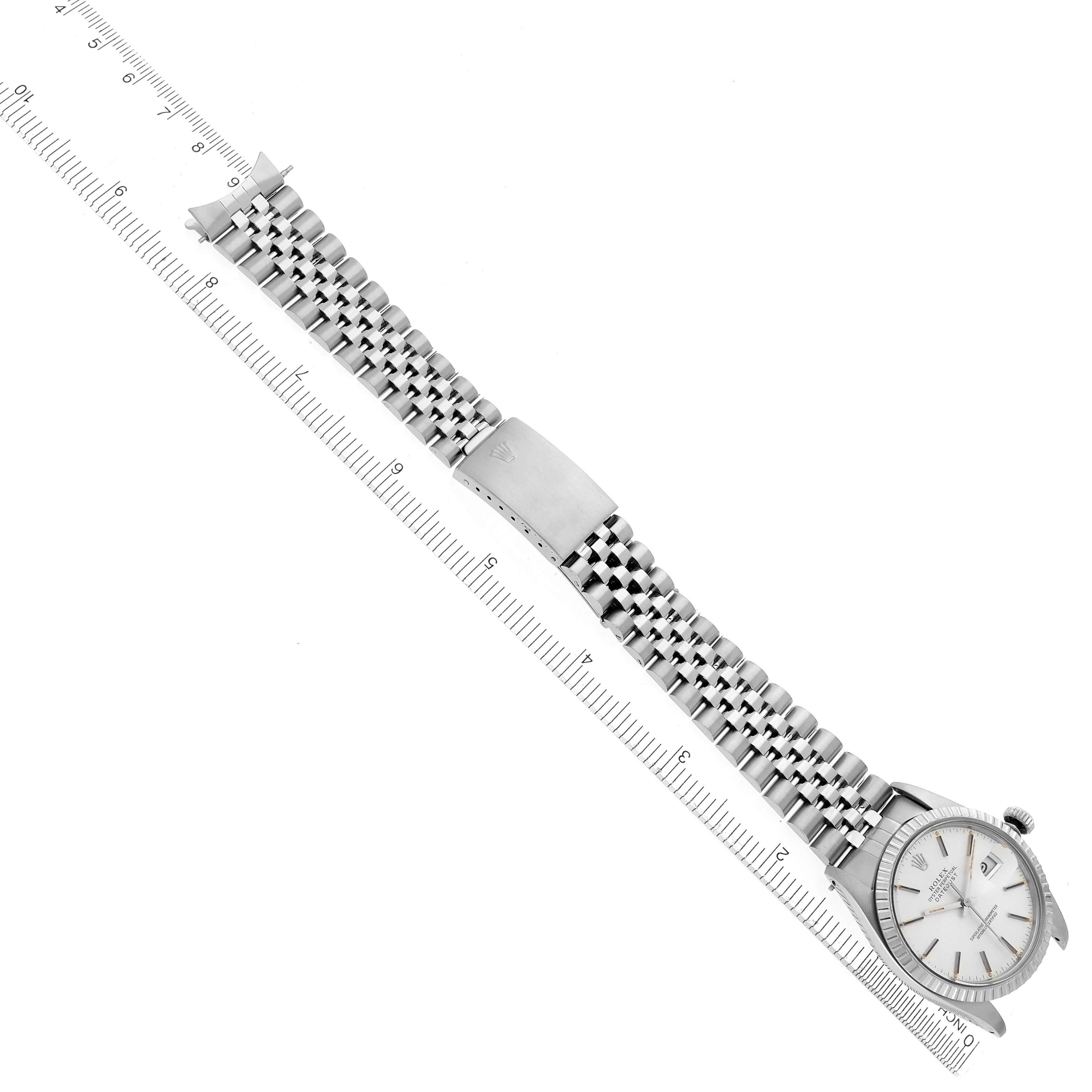The image shows a Rolex Datejust 16030 Men
s Stainless Steel Silver Dial 16030 Men
s Stainless Steel Silver Dial watch laid flat, displaying the full bracelet and clasp, alongside a measuring ruler.