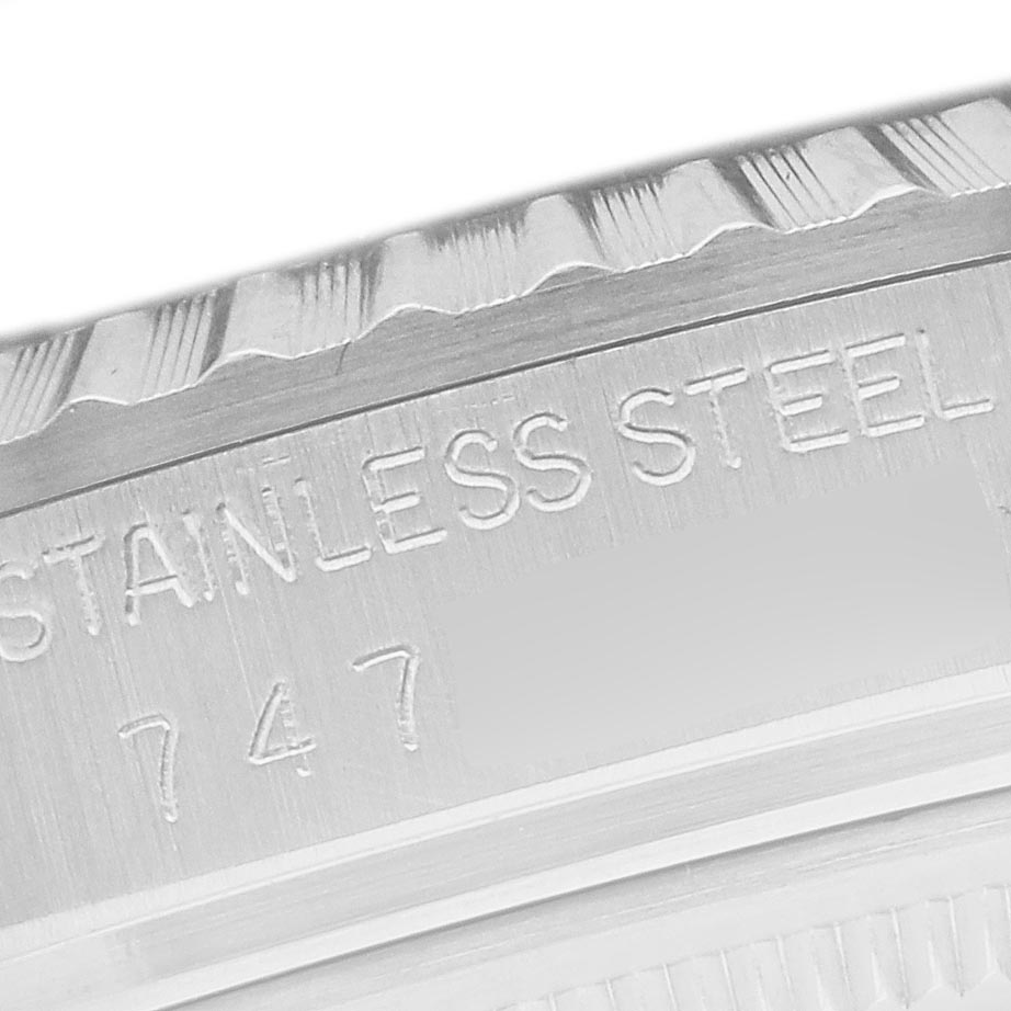 The image shows a close-up of the engraved edge of a Rolex Datejust 16030 Men
s Stainless Steel Silver Dial 16030 Men
s Stainless Steel Silver Dial watch, detailing the stainless steel material.