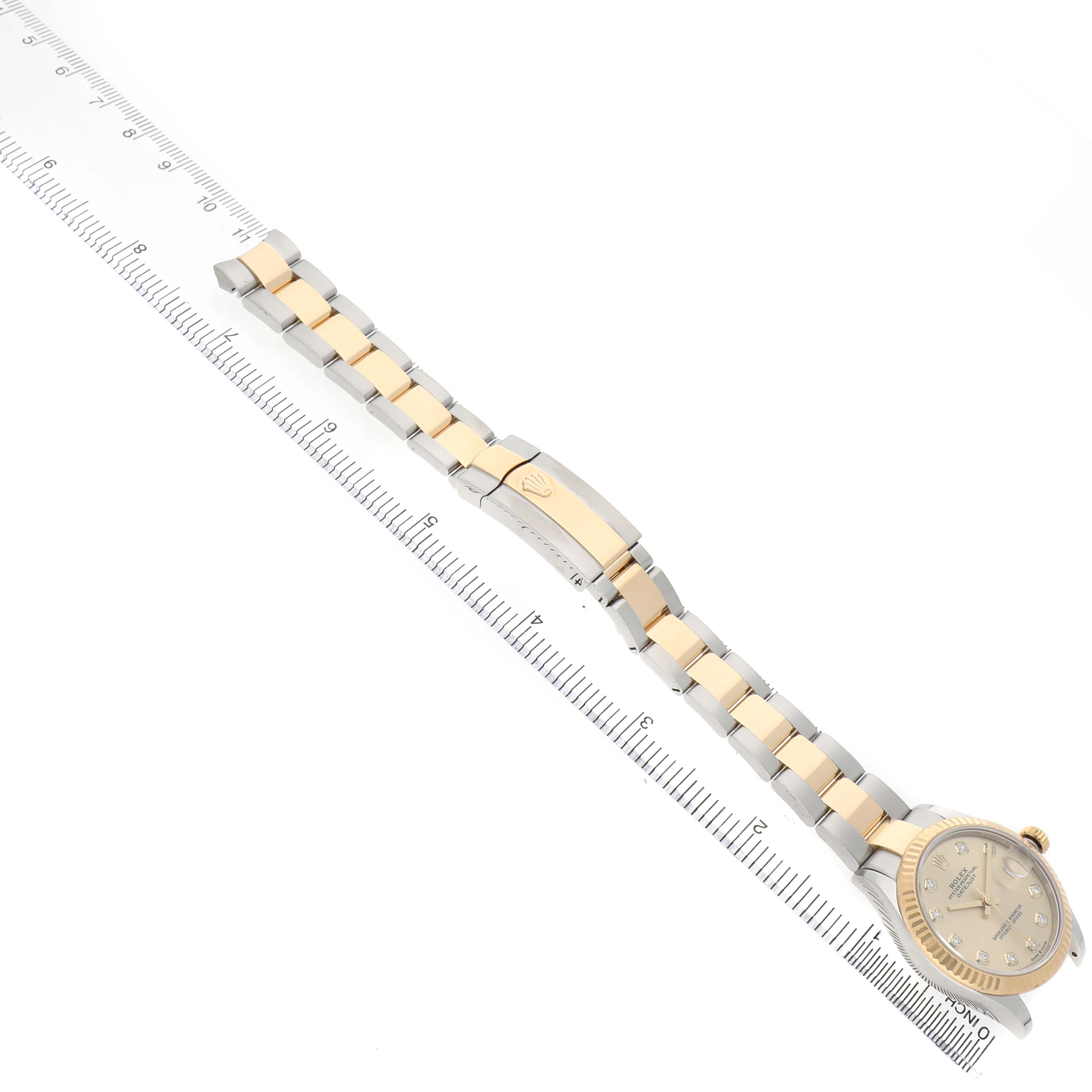 The Rolex Mid-Size 278273 Women's Steel and Gold (two tone) Champagne Dial model is shown at a diagonal angle, displaying the full bracelet and partial face.