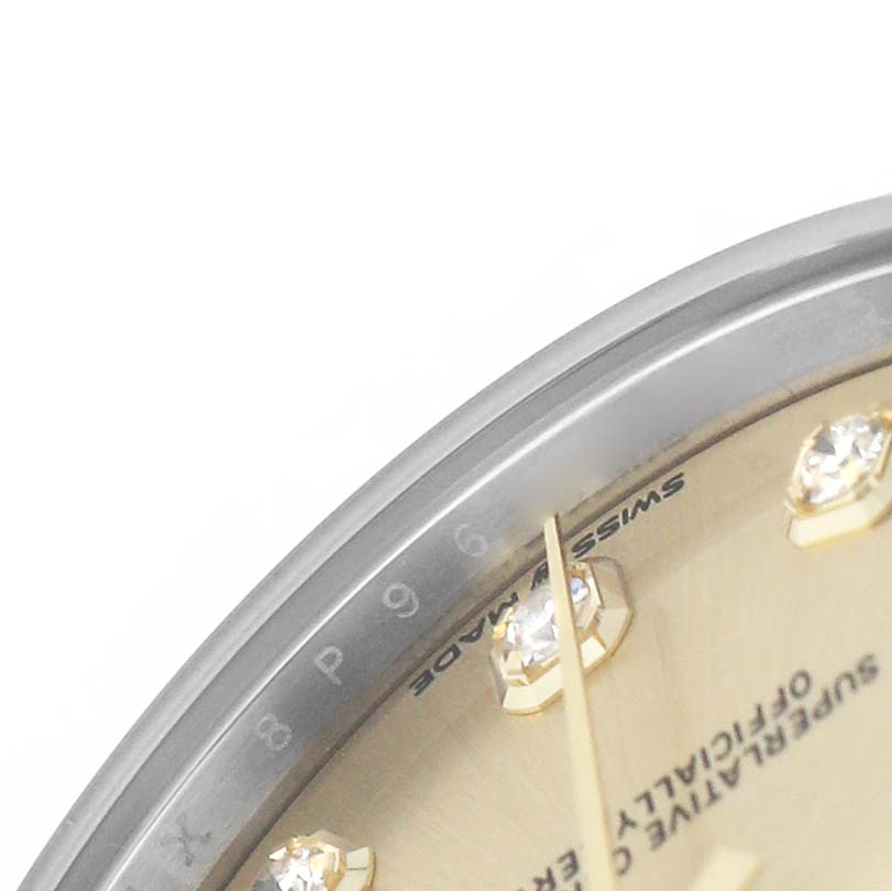 The image shows a close-up of the bezel, partial dial, and diamond hour markers of a Rolex Mid-Size 278273 Women's Steel and Gold (two tone) Champagne Dial watch.