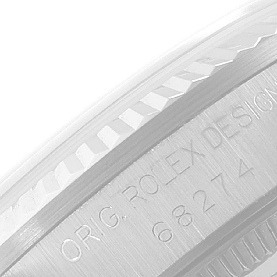 This close-up image displays the side view of the bezel and engraved casing of a Mid-Size Rolex watch.