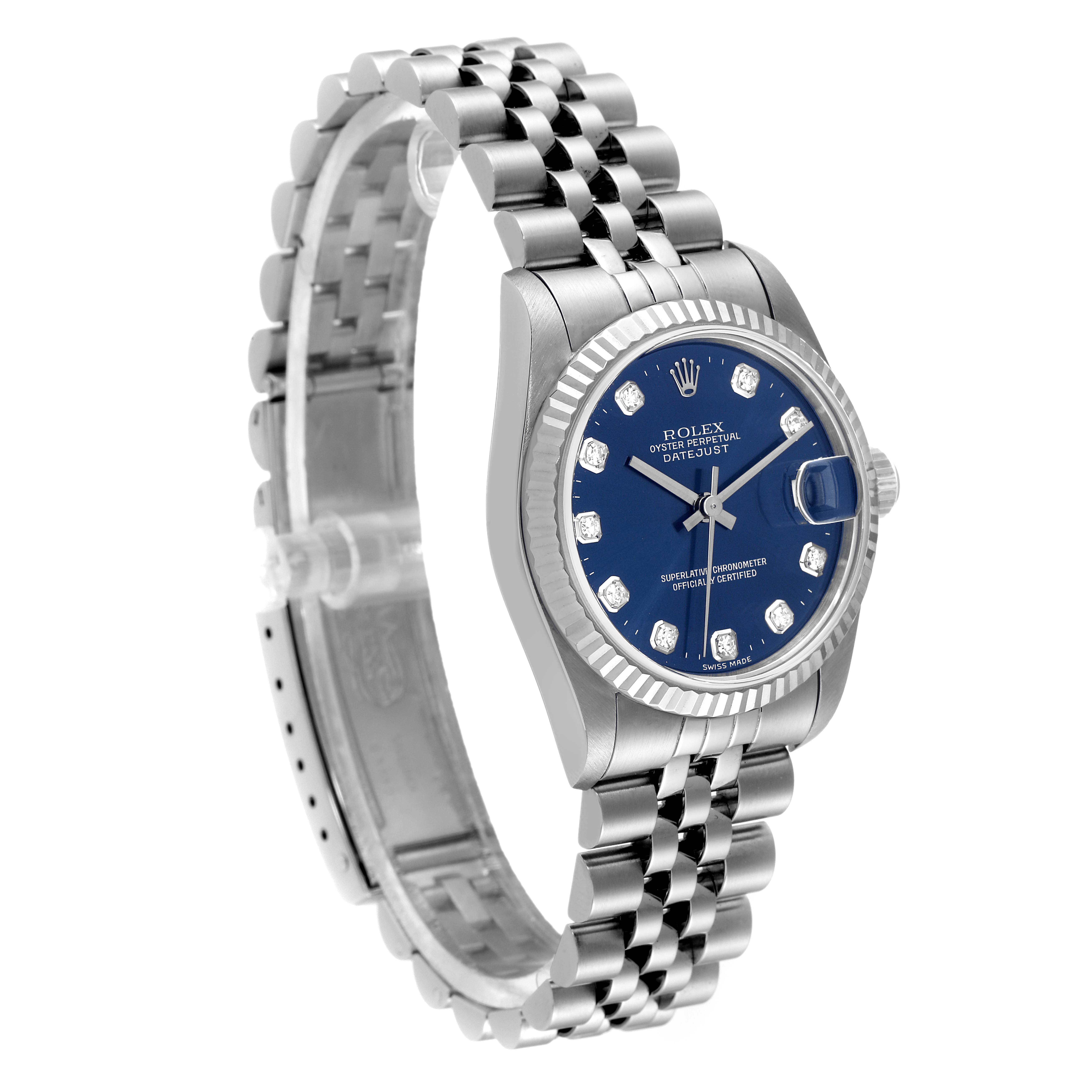 The image shows a Mid-Size Rolex Datejust watch from a front-left angle, featuring a blue dial, fluted bezel, and Jubilee bracelet.