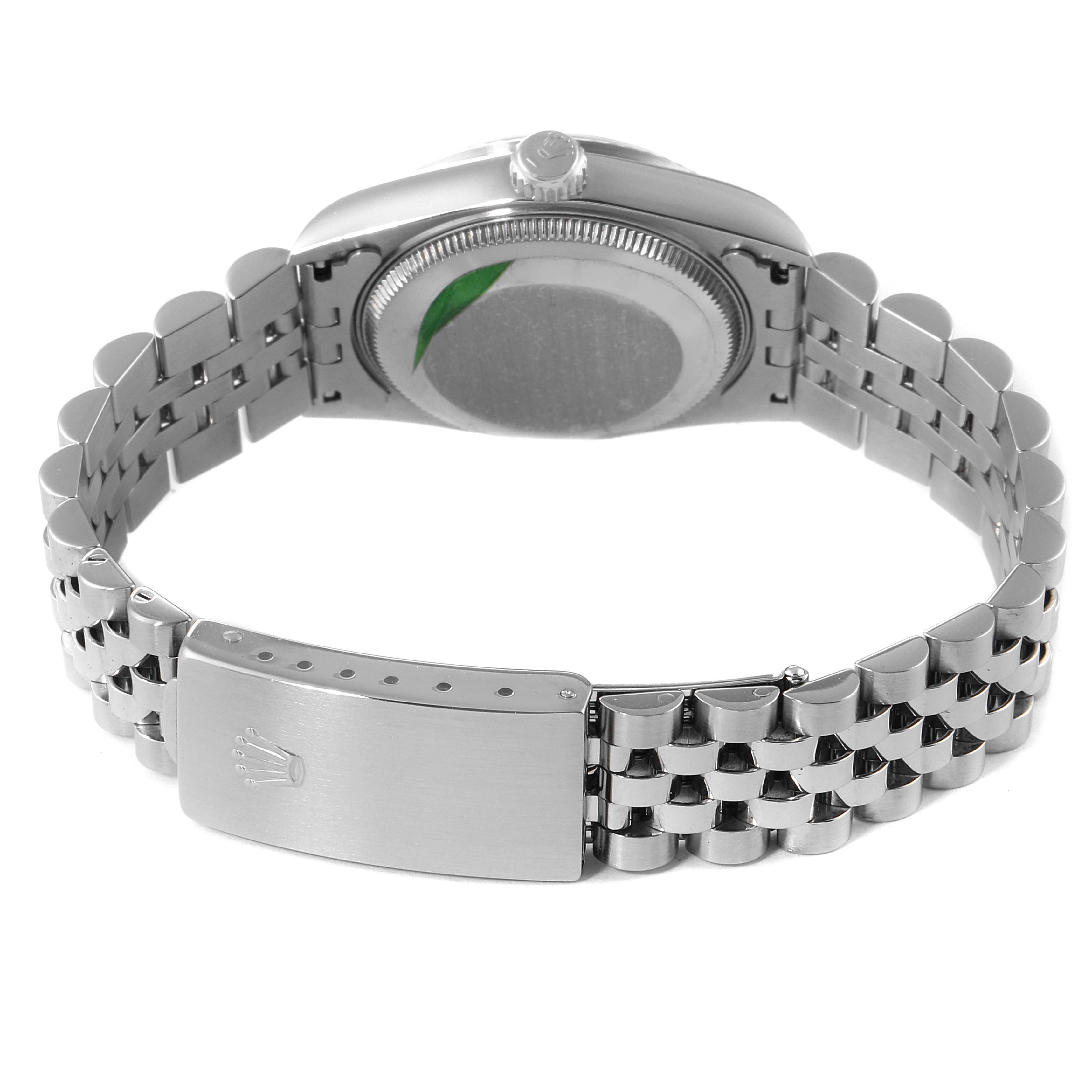 The image shows the back view of a Mid-Size Rolex watch, focusing on the case back and metal bracelet.