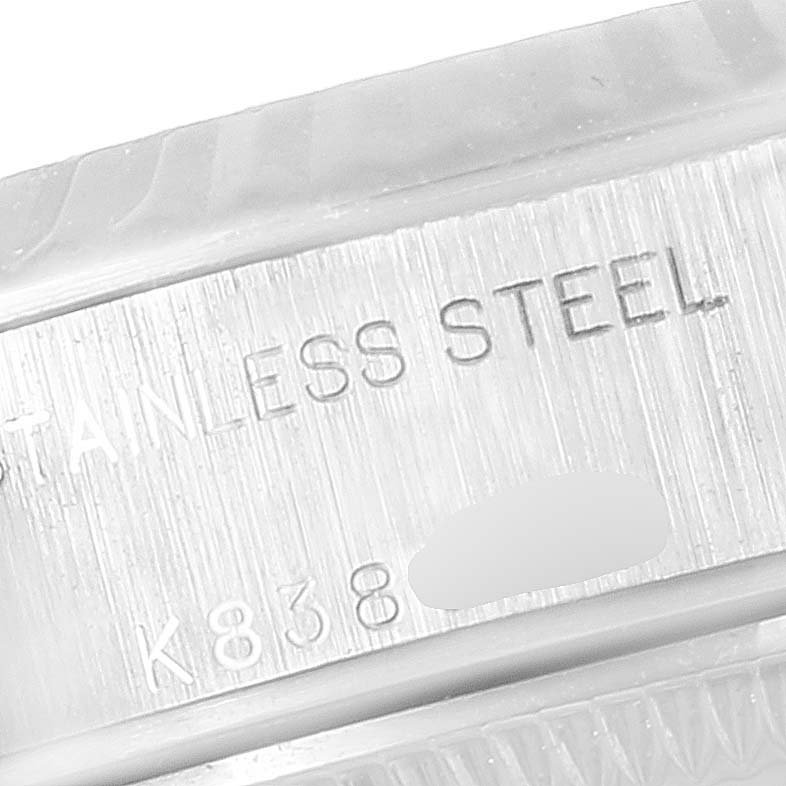This close-up image shows the serial number and "STAINLESS STEEL" engraving on the side of a Rolex Datejust 79174 Women's Stainless Steel Silver Dial 79174 Women's Stainless Steel Silver Dial watch case.