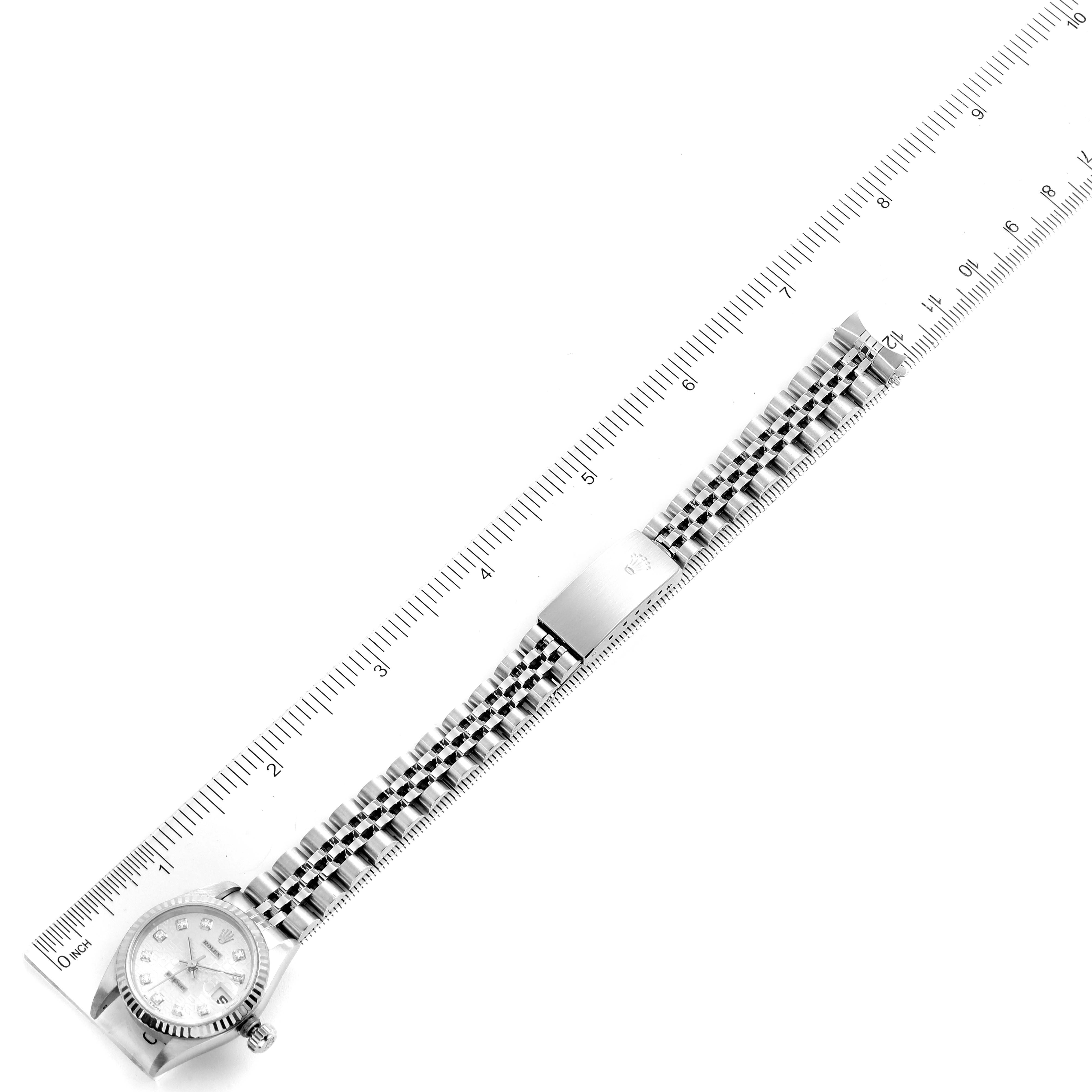 The image shows an overhead view of a Rolex Datejust 79174 Women's Stainless Steel Silver Dial 79174 Women's Stainless Steel Silver Dial watch, featuring the face, bezel, and full bracelet laid alongside a ruler.