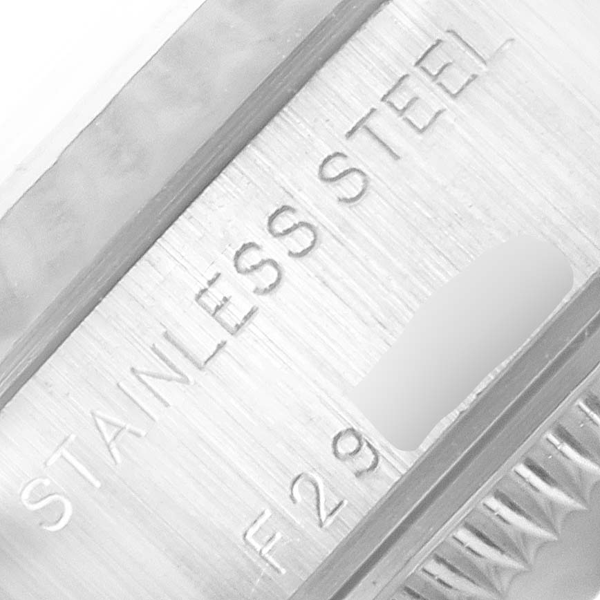 The image shows a close-up of the stainless steel part of a Rolex Datejust 79174 Women's Stainless Steel White Dial 79174 Women's Stainless Steel White Dial watch case, with partial engravings visible.