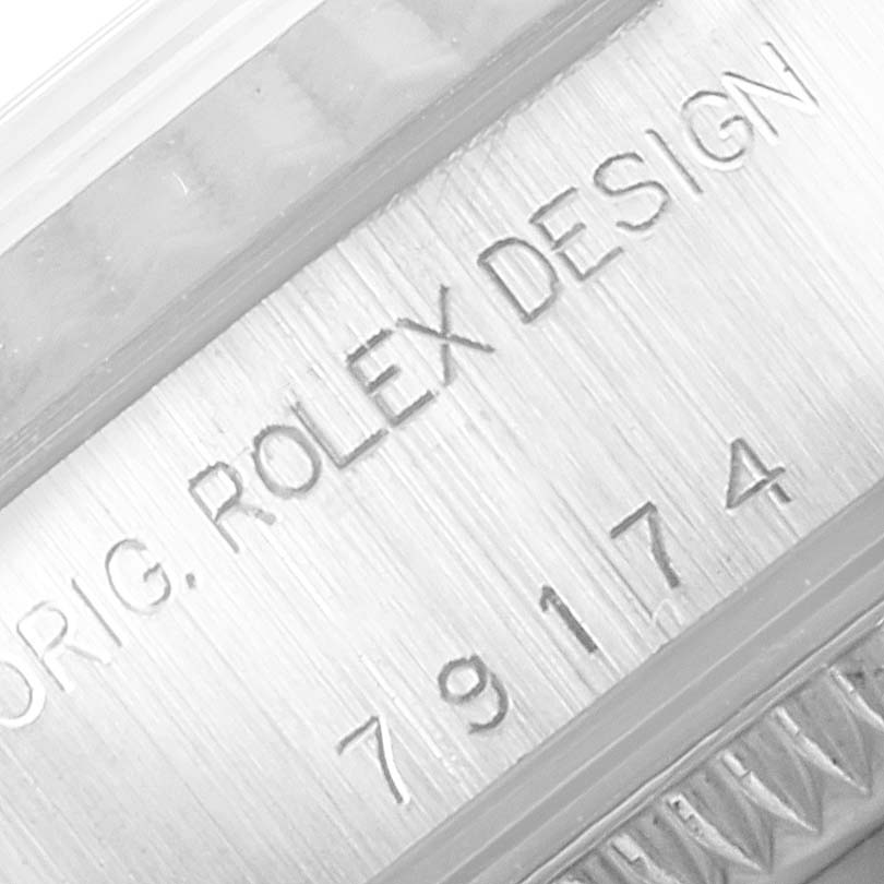 This image shows a close-up of the engraved serial number and "ROLEX DESIGN" text on the case back of a Rolex Datejust 79174 Women's Stainless Steel White Dial 79174 Women's Stainless Steel White Dial watch.