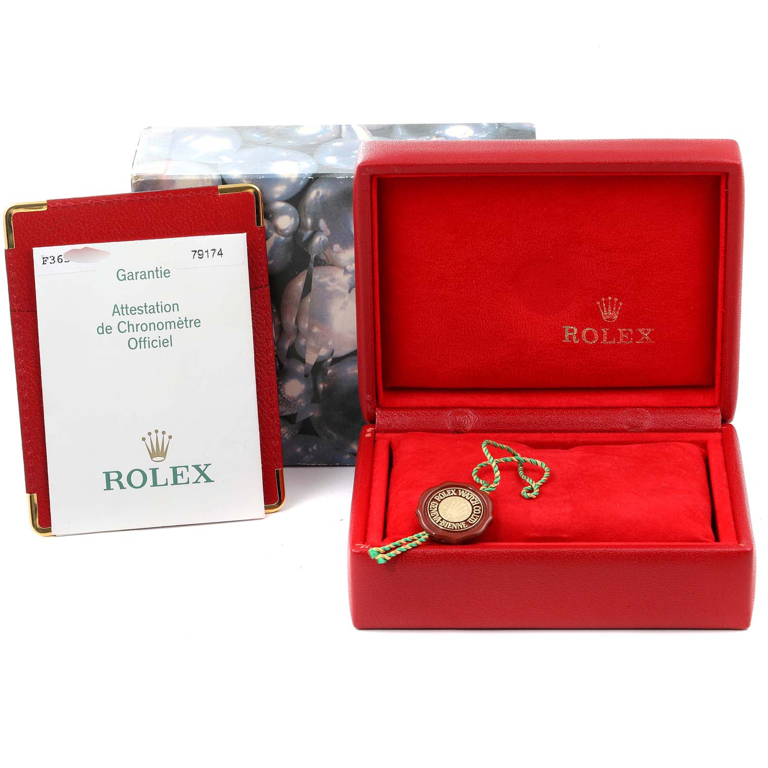 The image shows a Rolex Datejust 79174 Women's Stainless Steel Silver Dial 79174 Women's Stainless Steel Silver Dial watch box, a tag with a string, and the official warranty certificate.