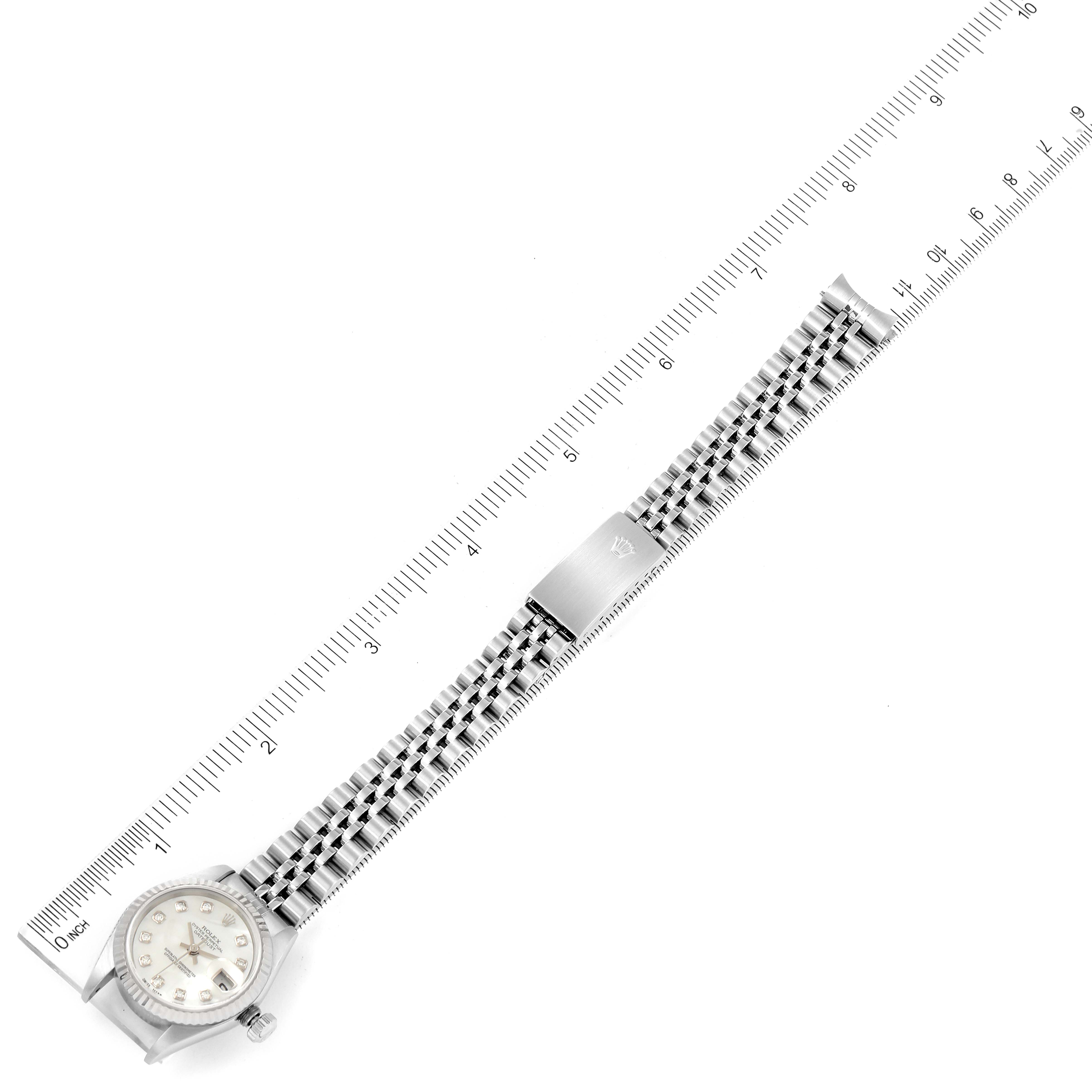 The image shows a Rolex Datejust 79174 Women's Stainless Steel Mother of Pearl Dial 79174 Women's Stainless Steel Mother of Pearl Dial watch laid flat, with its bracelet and clasp fully extended along a measuring ruler.