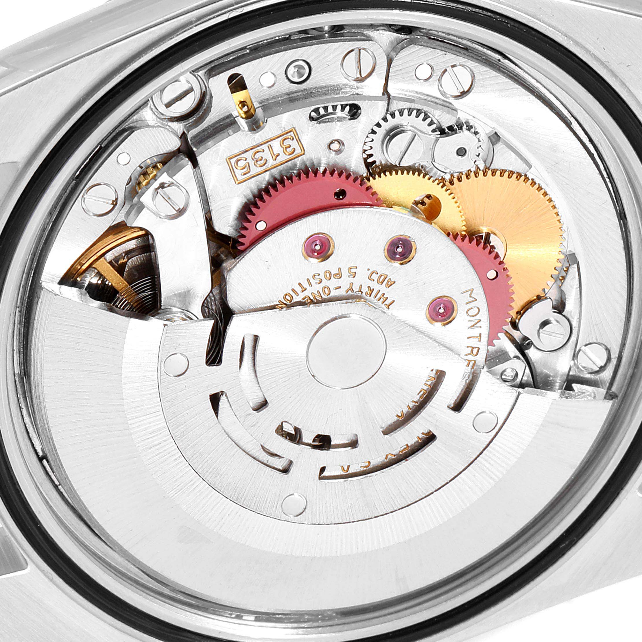 The image shows the intricate inner mechanism of the Rolex Datejust 41 16233 Men's Steel and Gold (two tone) Black Dial 16233 Men's Steel and Gold (two tone) Black Dial watch, focusing on the movement and gears.