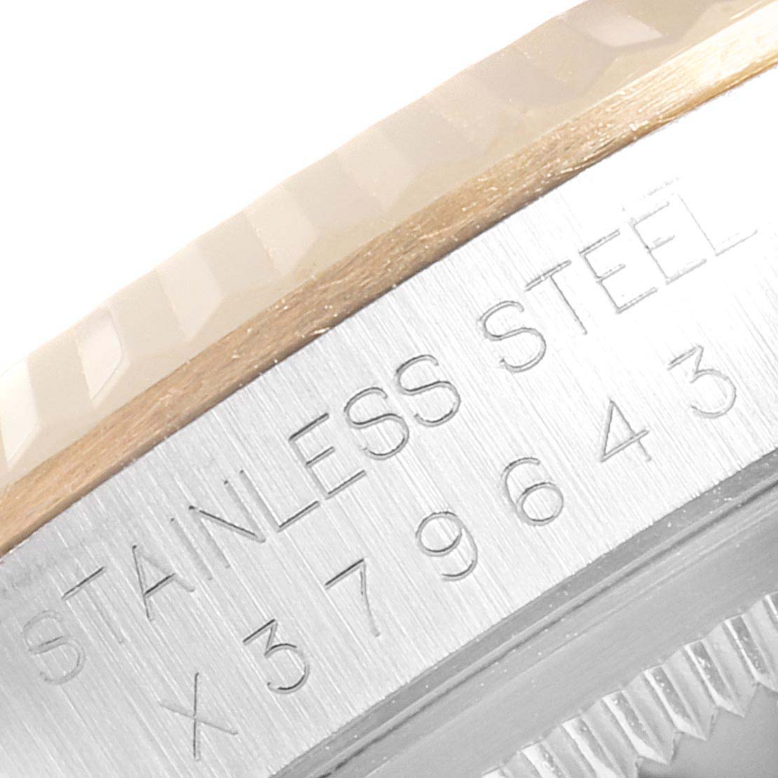 This close-up shows the engraved serial number and part of the bezel of the Rolex Datejust 41 16233 Men's Steel and Gold (two tone) Black Dial 16233 Men's Steel and Gold (two tone) Black Dial model.