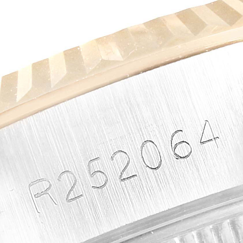 The image shows a close-up of the serial number engraving and part of the bezel on a Rolex Datejust 69173 Women's Steel and Gold (two tone) Silver Dial 69173 Women's Steel and Gold (two tone) Silver Dial watch.