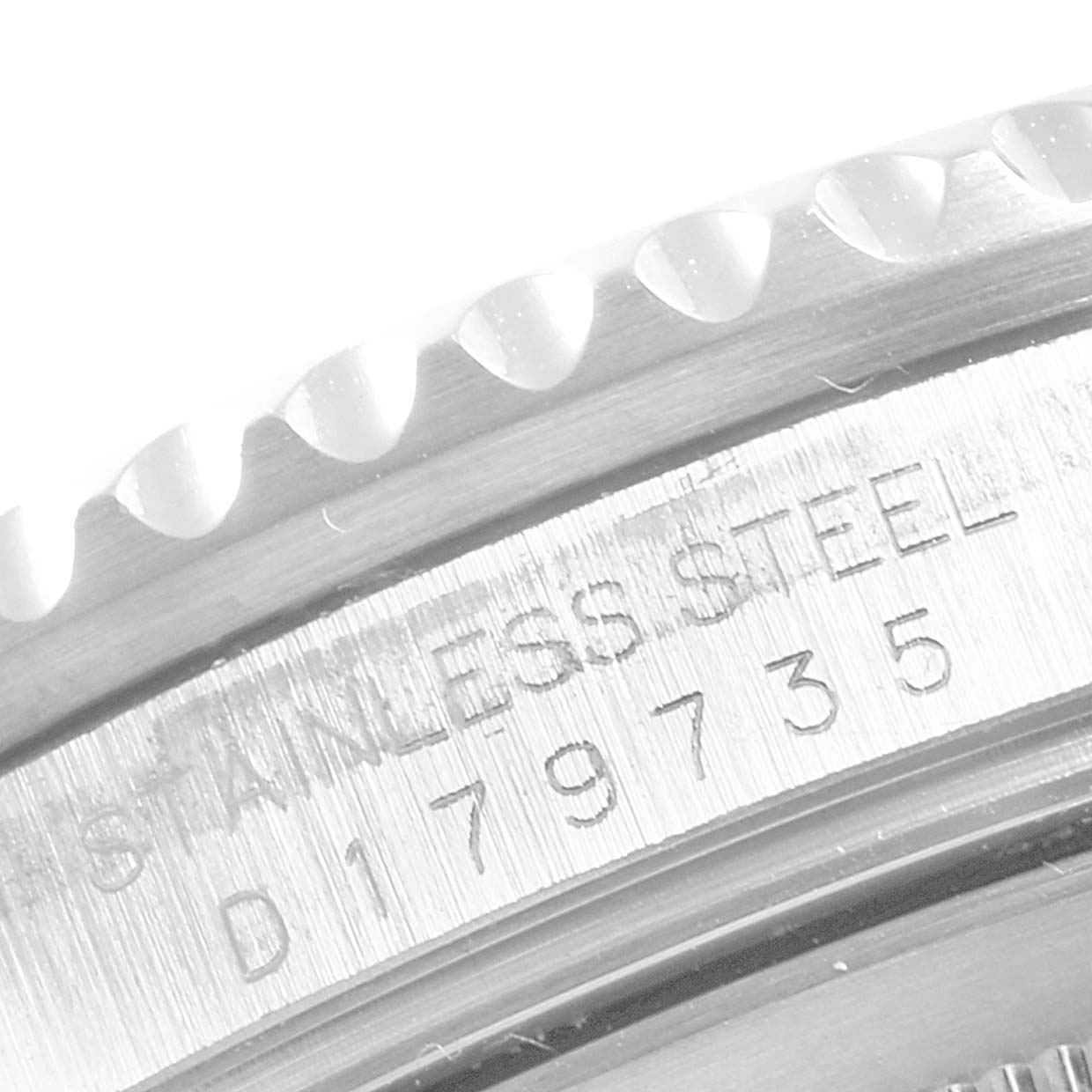 This close-up image of the GMT-Master Rolex watch shows the detailed engraving of the serial number and part of the bezel.
