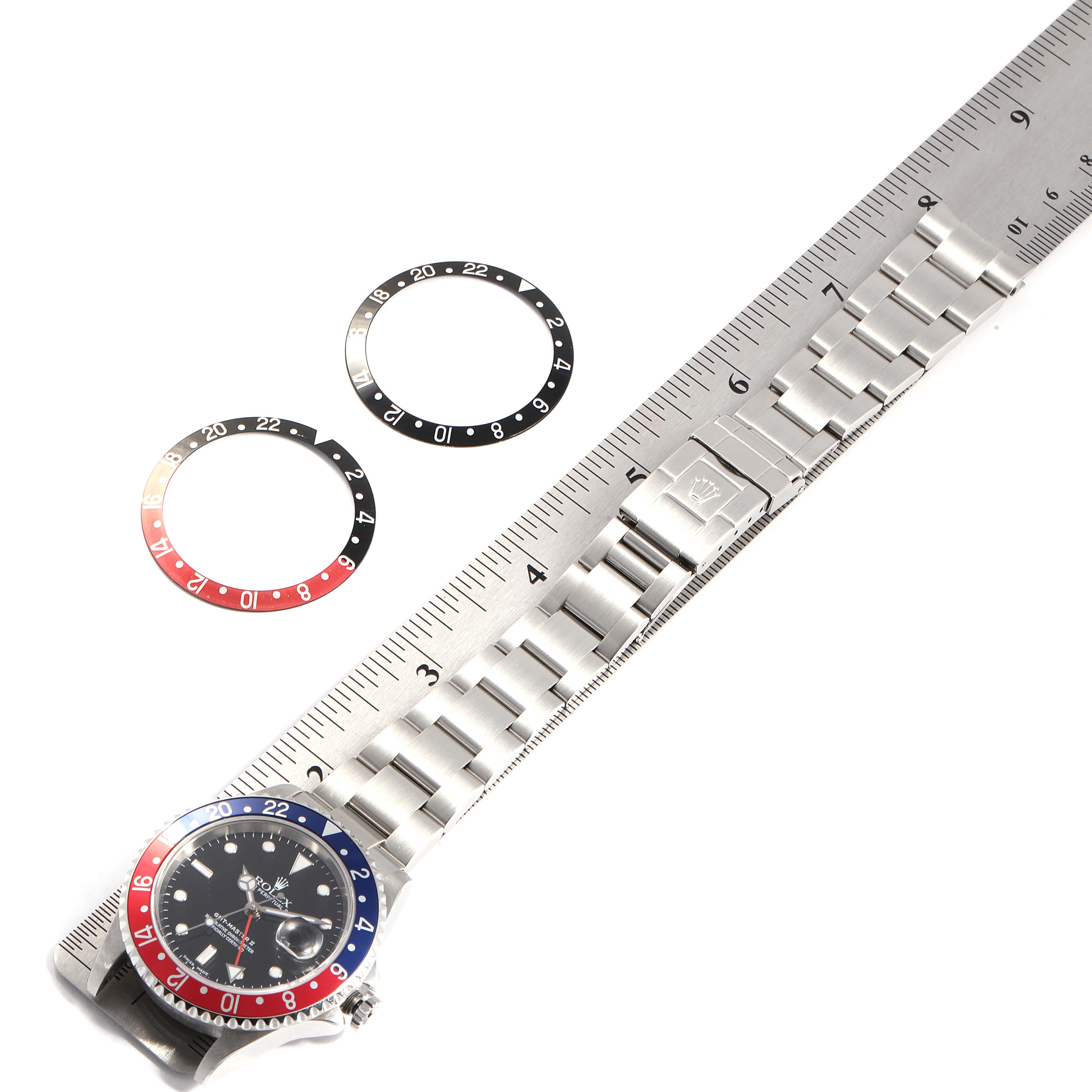 The image shows a Rolex GMT-Master 16710 Men's Stainless Steel Black Dial 16710 Men's Stainless Steel Black Dial watch with a ruler, two bezel inserts, and a portion of the bracelet.