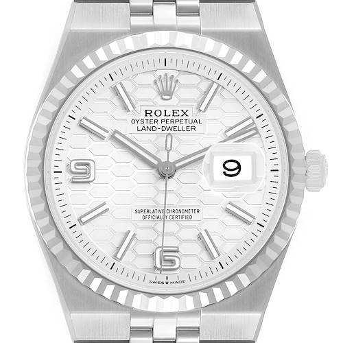 The Rolex Land-Dweller is shown from a top-down angle, displaying the dial, bezel, hands, and bracelet.