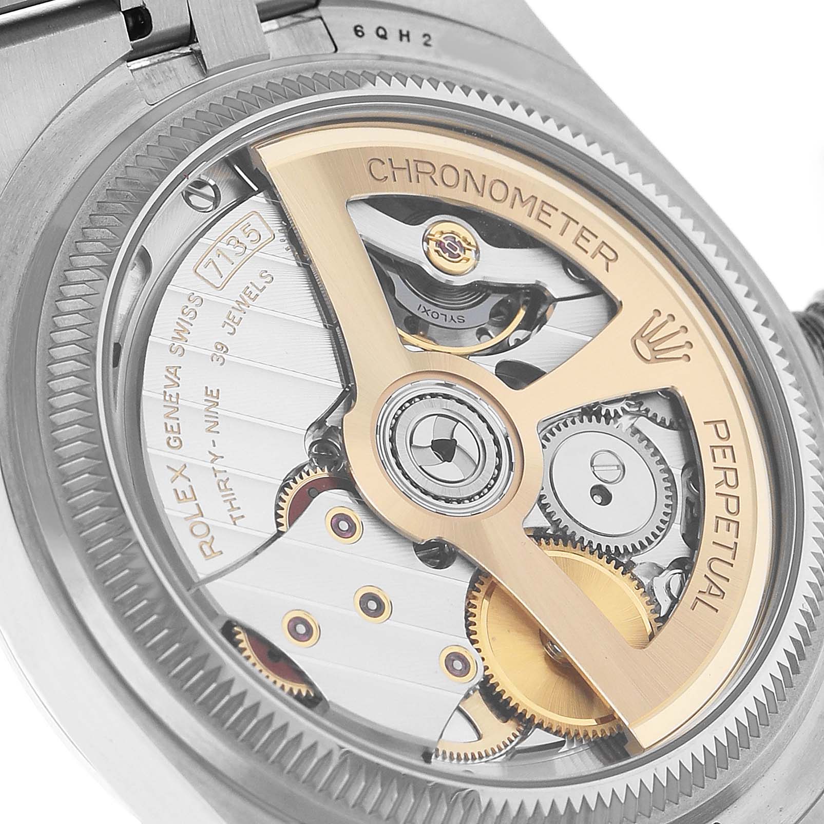 The image shows the backside view of a Rolex Land-Dweller, highlighting its movement and rotor.