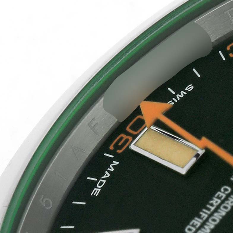 The image shows a close-up of the dial and part of the bezel of a Rolex Milgauss M116400GV-0001 Men's Stainless Steel Black Dial, highlighting the orange lightning bolt second hand and numerals.