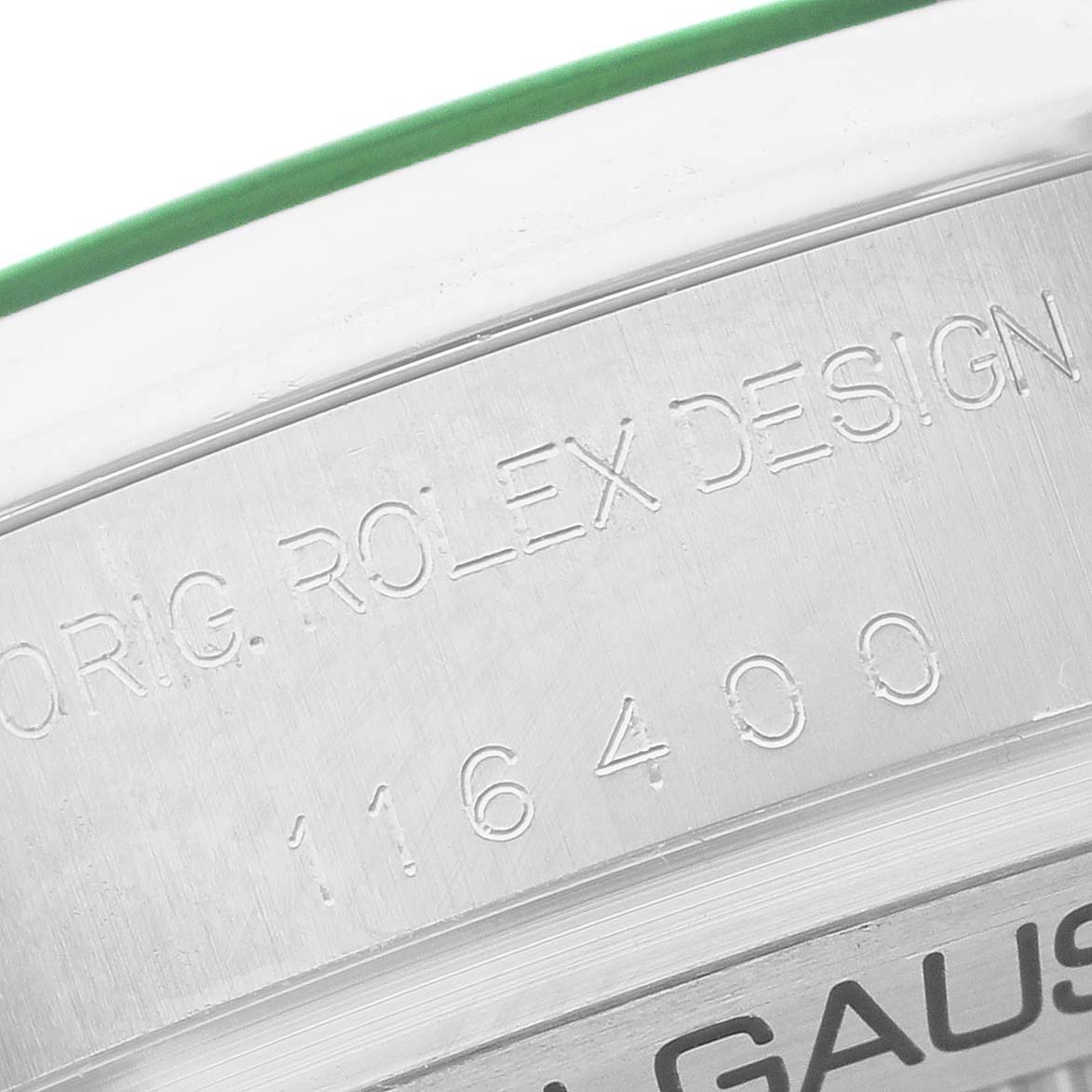 The image shows a close-up of the side of a Rolex Milgauss M116400GV-0001 Men's Stainless Steel Black Dial watch, highlighting the engraved model number "116400" and lettering.
