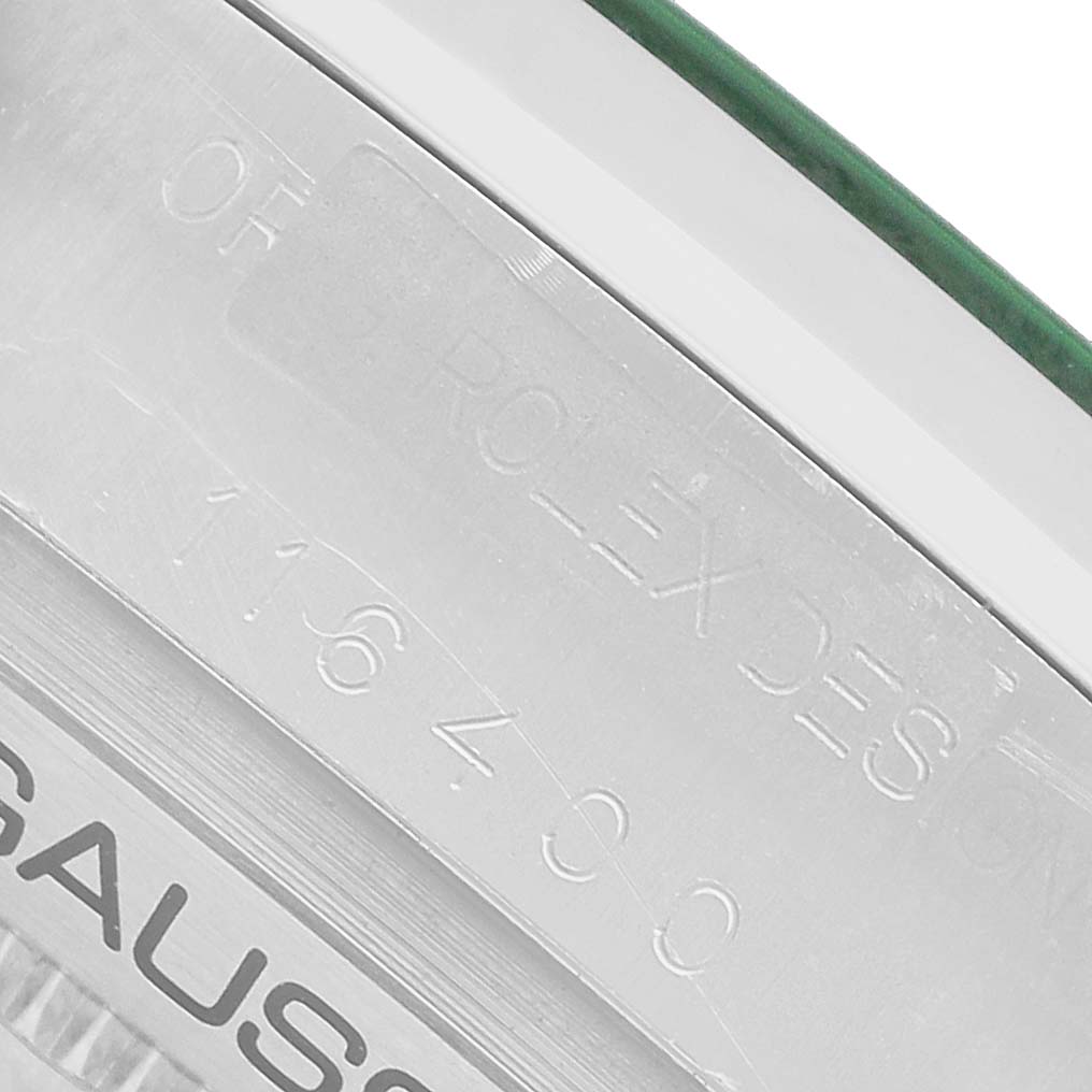 The image shows the engraved side of a Rolex Milgauss 116400GV Men's Stainless Steel Black Dial watch case, highlighting model details.