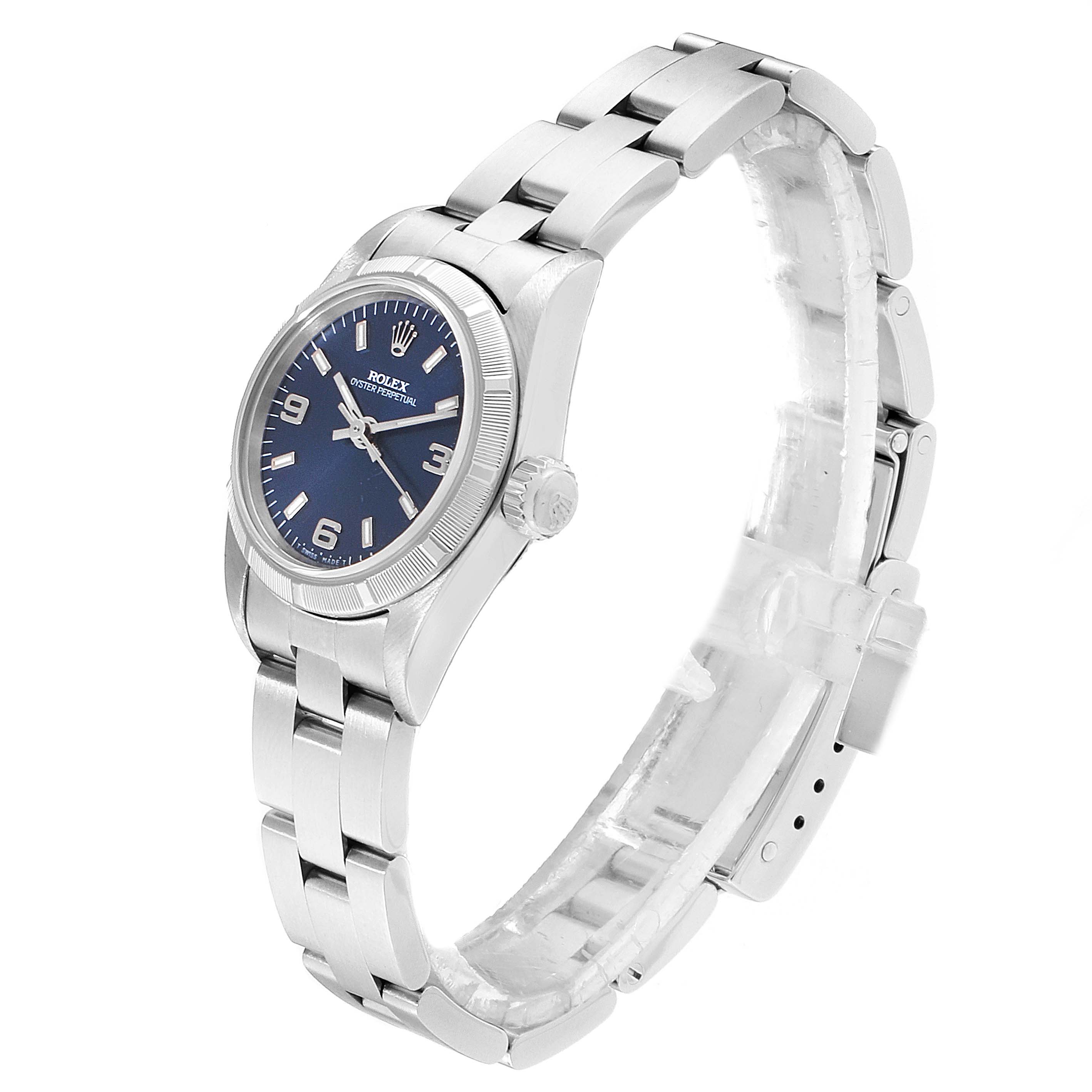 This is a side angle view of a Rolex Oyster Perpetual 67230 Women
s Stainless Steel Blue Dial 67230 Women
s Stainless Steel Blue Dial watch, displaying the dial, bezel, crown, and bracelet.
