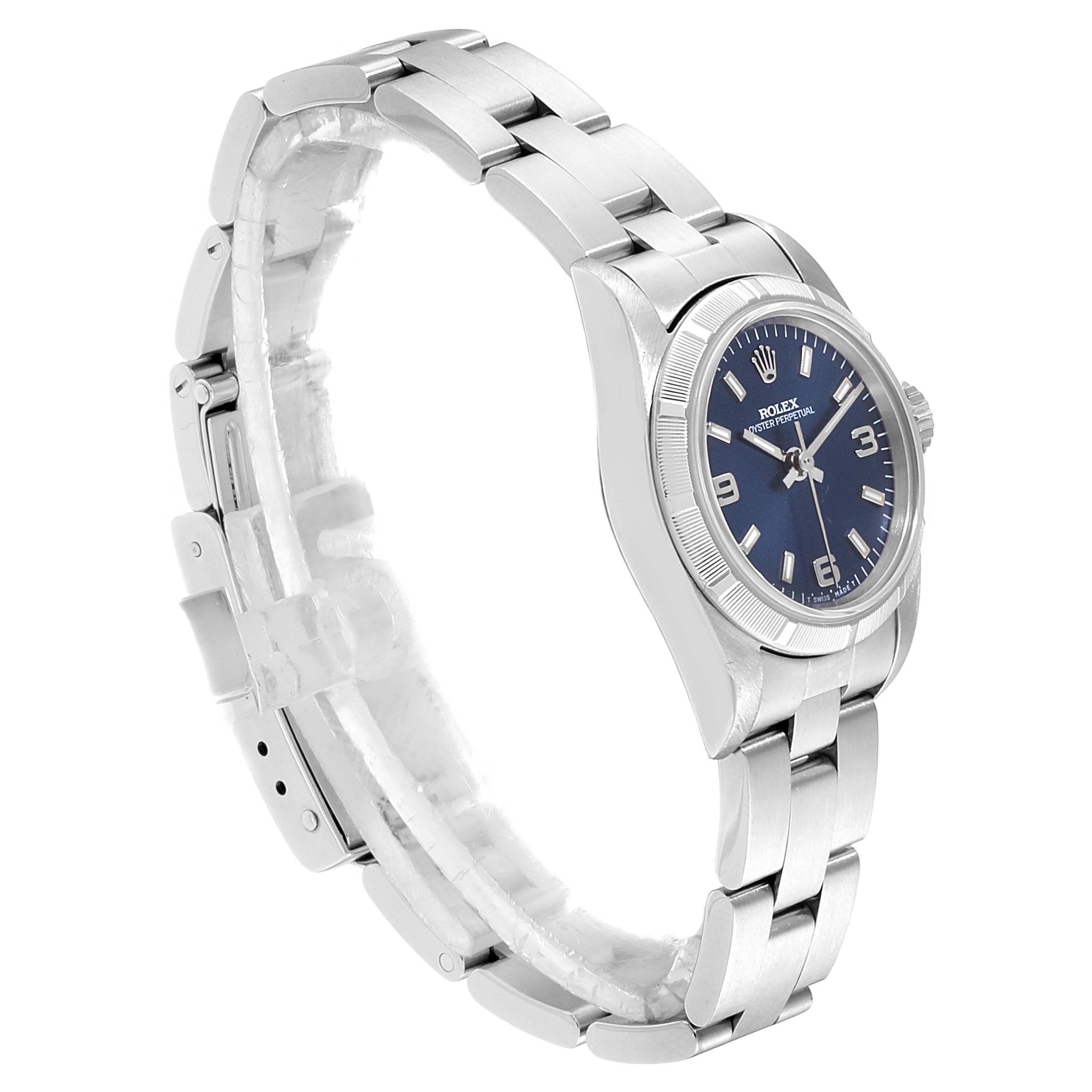 The image shows a side angle of a Rolex Oyster Perpetual 67230 Women
s Stainless Steel Blue Dial 67230 Women
s Stainless Steel Blue Dial watch, highlighting the bracelet, case, and blue dial.
