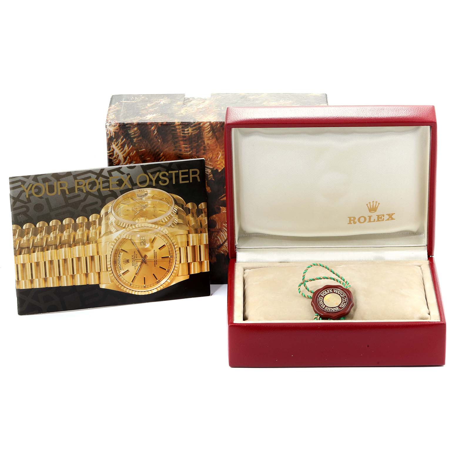 The image shows a Rolex President 69278 Women
s Yellow Gold Champagne Dial 69278 Women
s Yellow Gold Champagne Dial model watch box, a booklet, and a tag accessory.