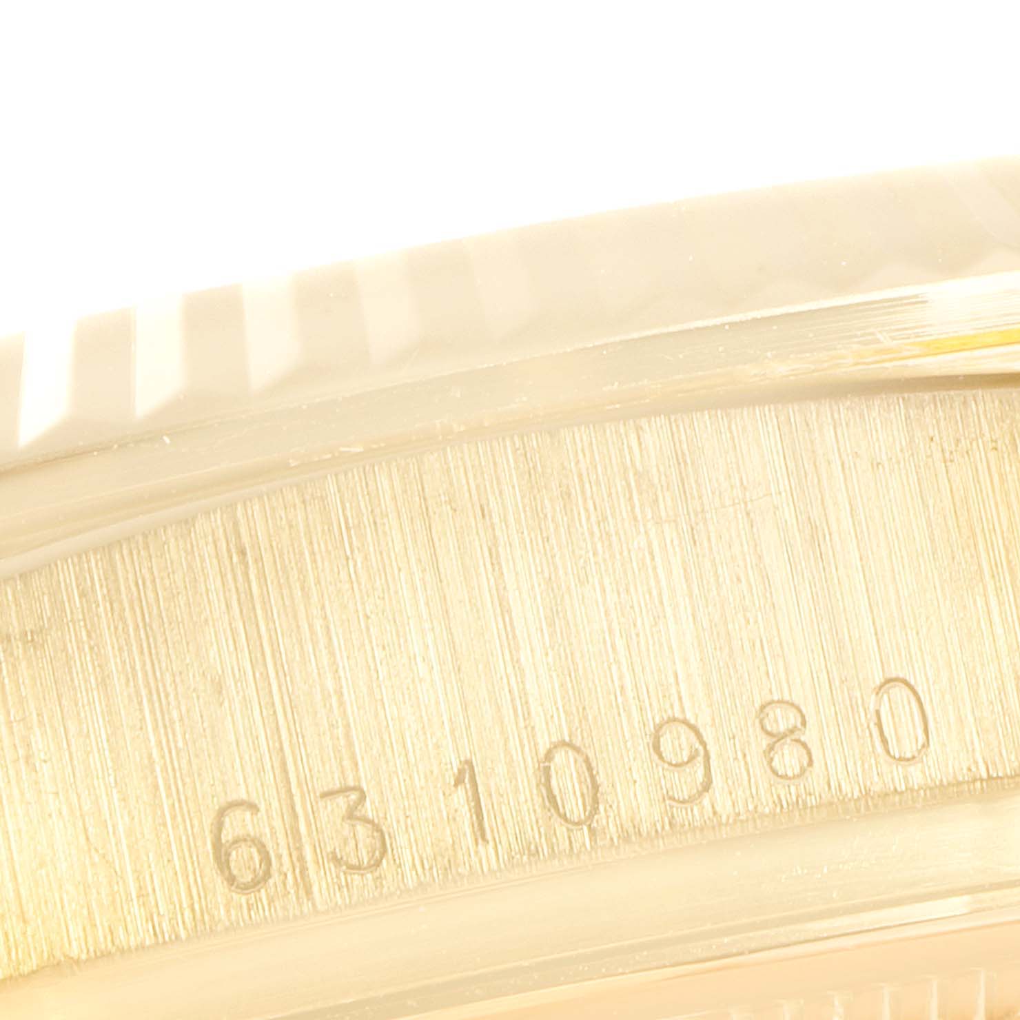 This close-up image shows the serial number engraving on the side of a Rolex President 18038 Men's Yellow Gold Champagne Dial 18038 Men's Yellow Gold Champagne Dial model watch.