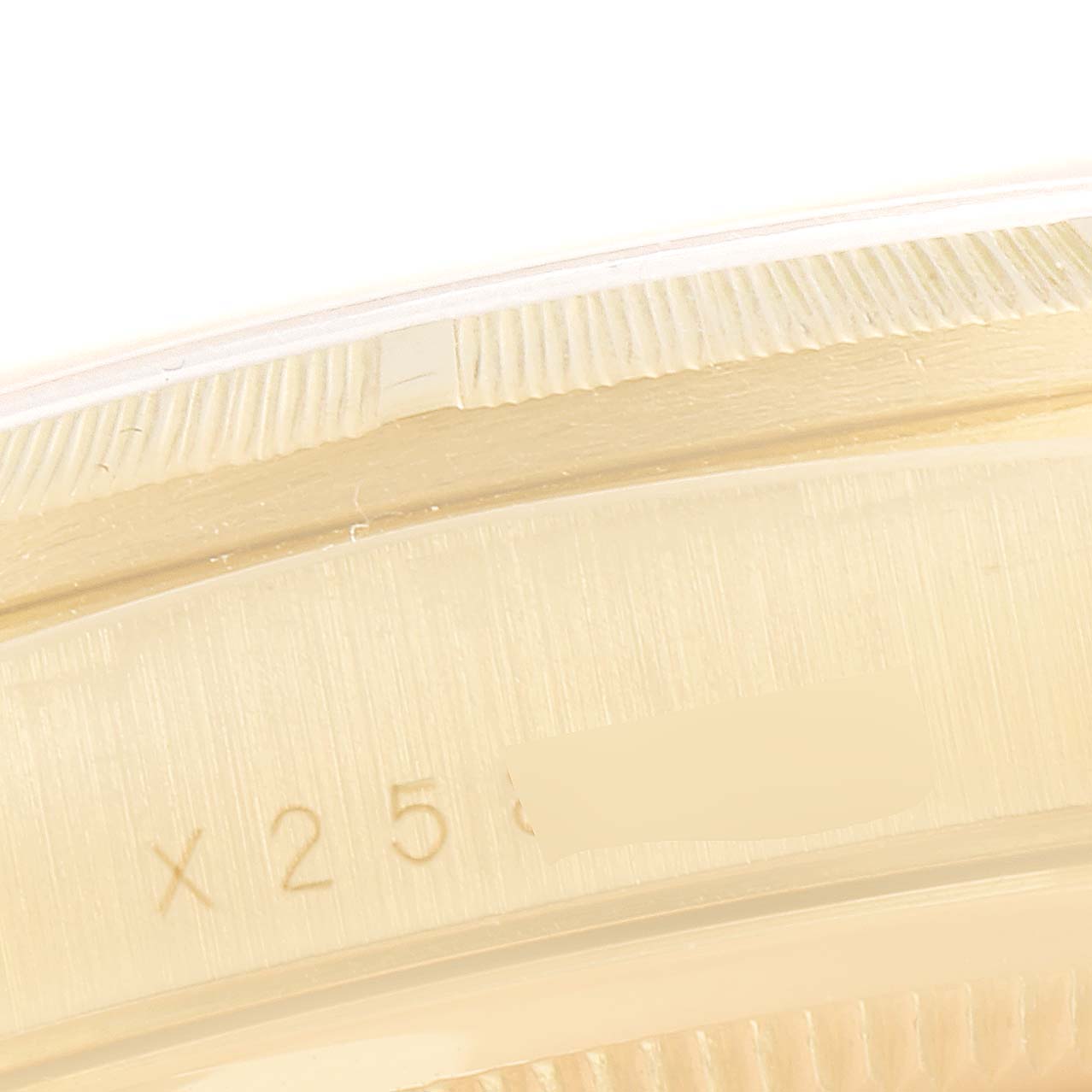 This image shows a close-up of the engraved serial number and fluted bezel from a Rolex President 18248 Men
s Yellow Gold Champagne Dial 18248 Men
s Yellow Gold Champagne Dial model watch.