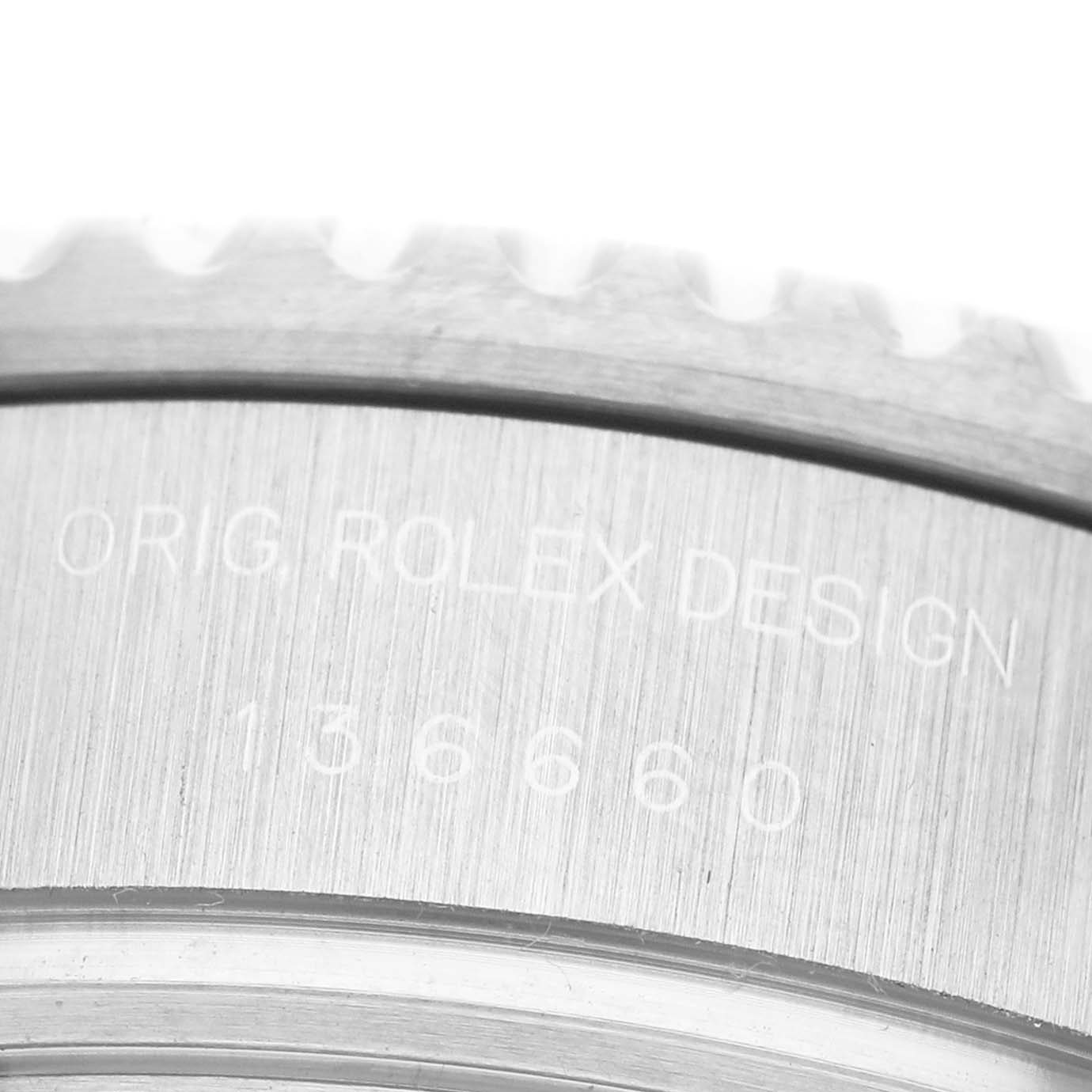 The image shows a close-up of the engraved text on the bezel of a Rolex Sea-Dweller 136660 Men's Stainless Steel Blue Dial, focused on the case side.