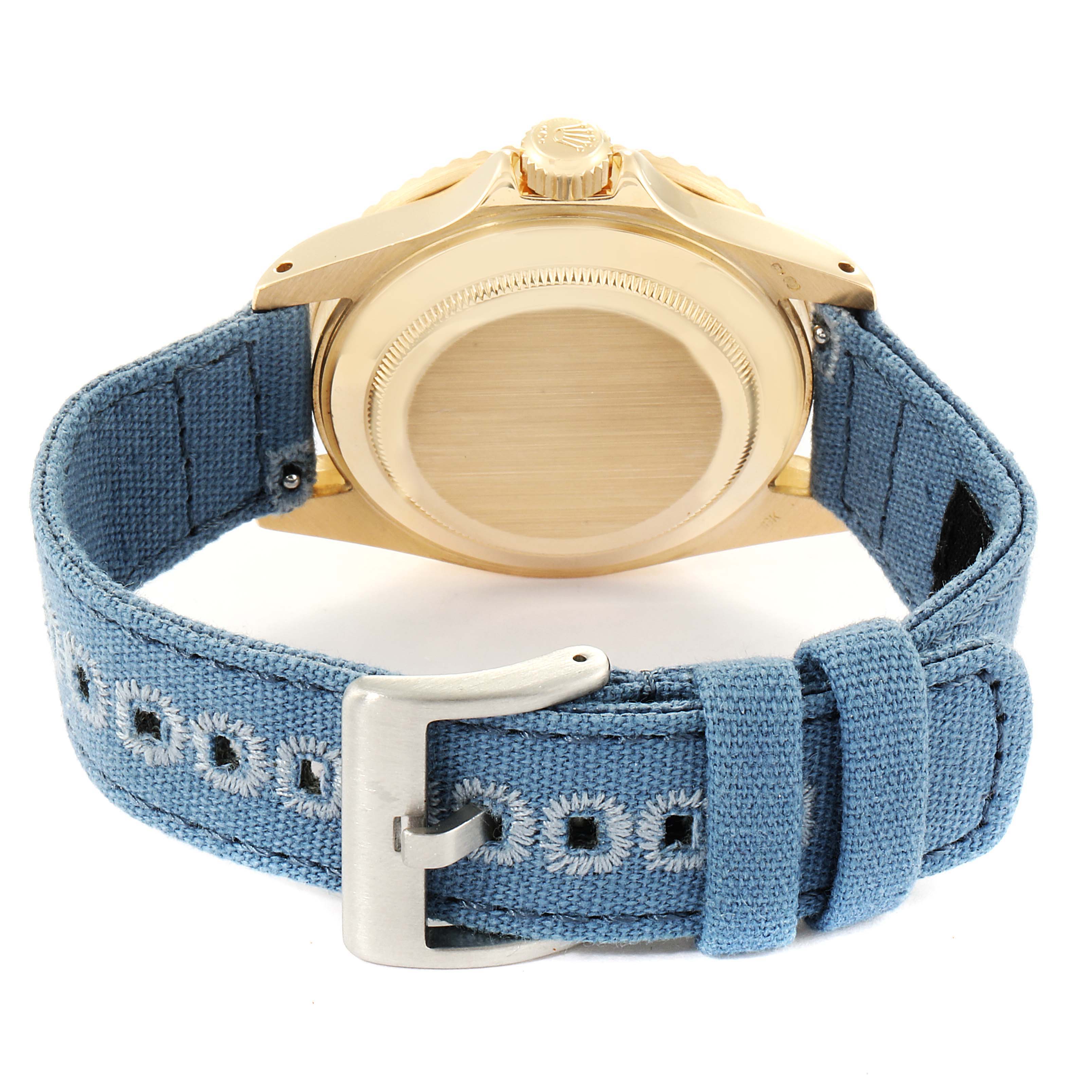 The image shows the rear view of a Rolex Submariner 16808 Men
s Yellow Gold Blue Dial 16808 Men
s Yellow Gold Blue Dial, highlighting the case back and a blue fabric strap with a buckle.