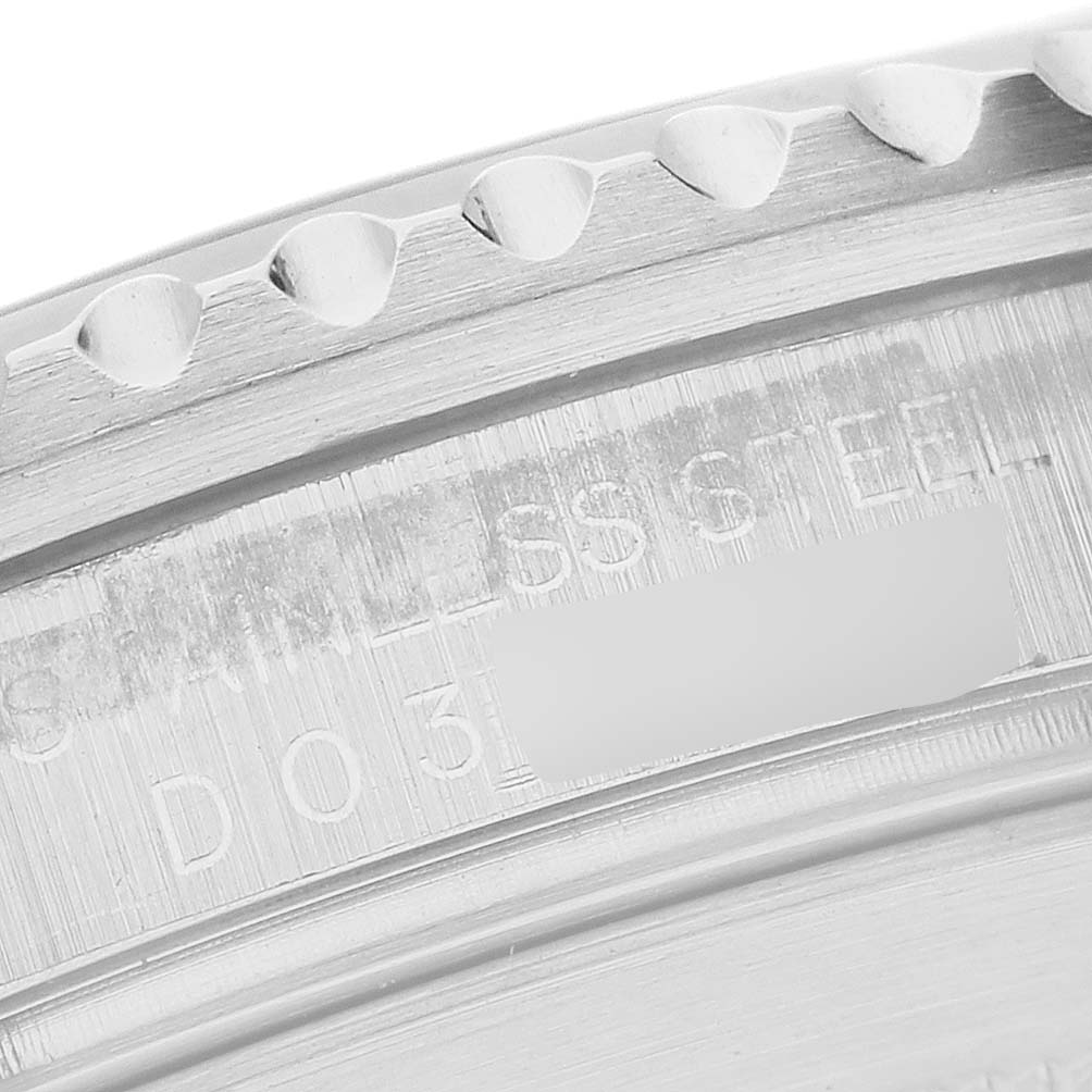 The image shows a close-up of the engraving on the edge of the Rolex Submariner 16610 Men's Stainless Steel Black Dial watch's stainless steel case.