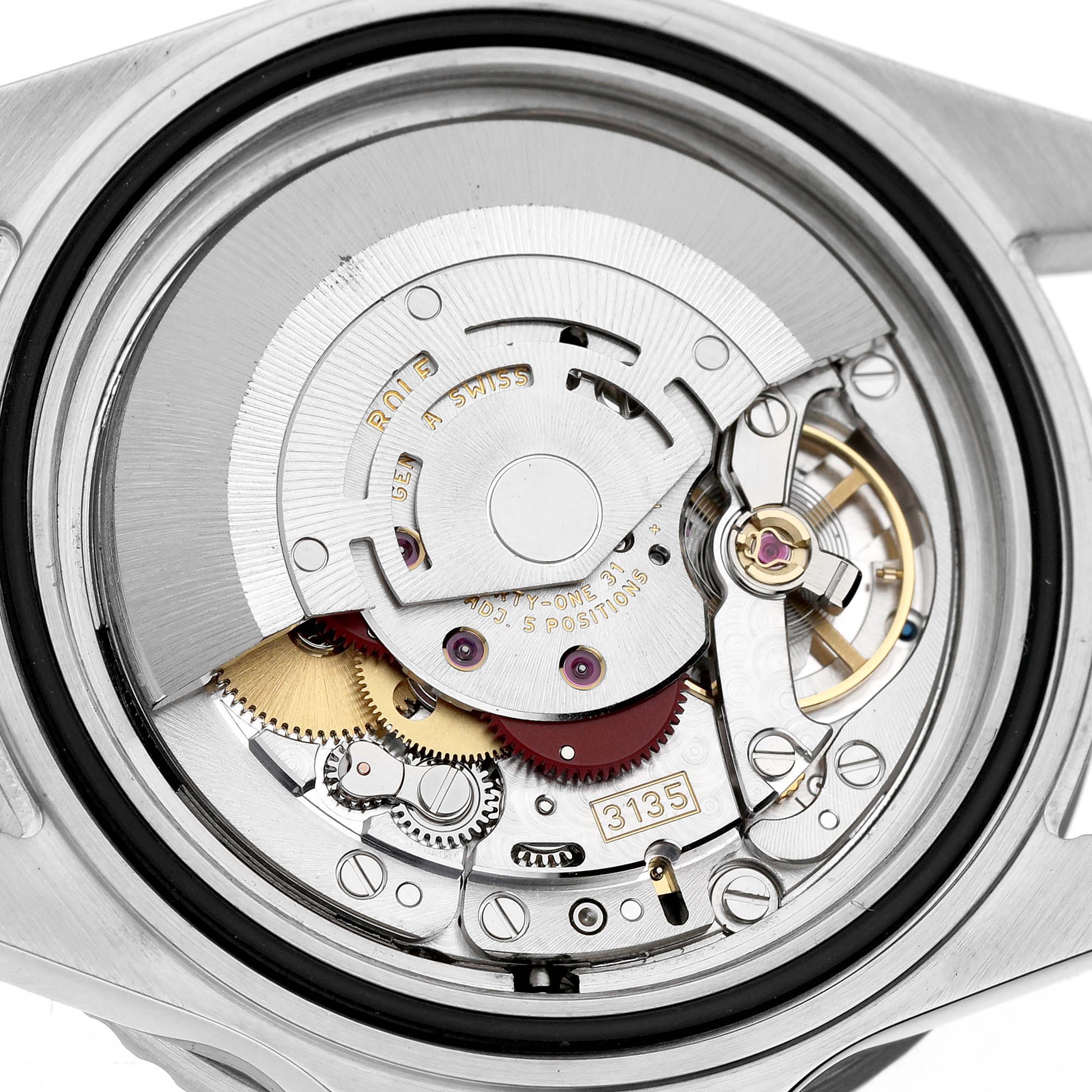 The image shows the internal mechanism of a Rolex Submariner 16610 Men's Stainless Steel Black Dial watch, highlighting the movement and gears from the back.