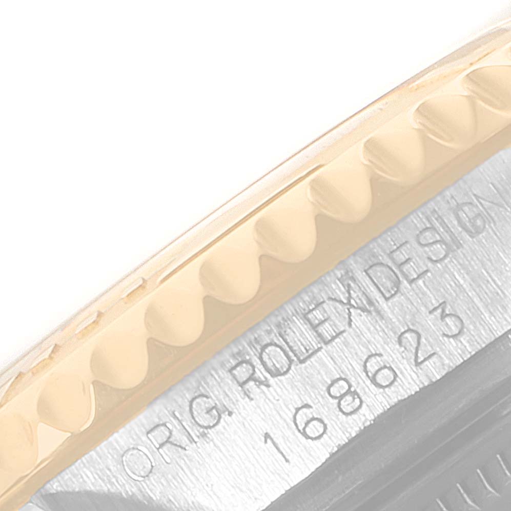 This image shows a close-up of the Rolex Yacht-Master 168623 Men
s Steel and Gold (two tone) Grey Dial 168623 Men
s Steel and Gold (two tone) Grey Dial model
s bezel and part of the case with engraved text on the side.