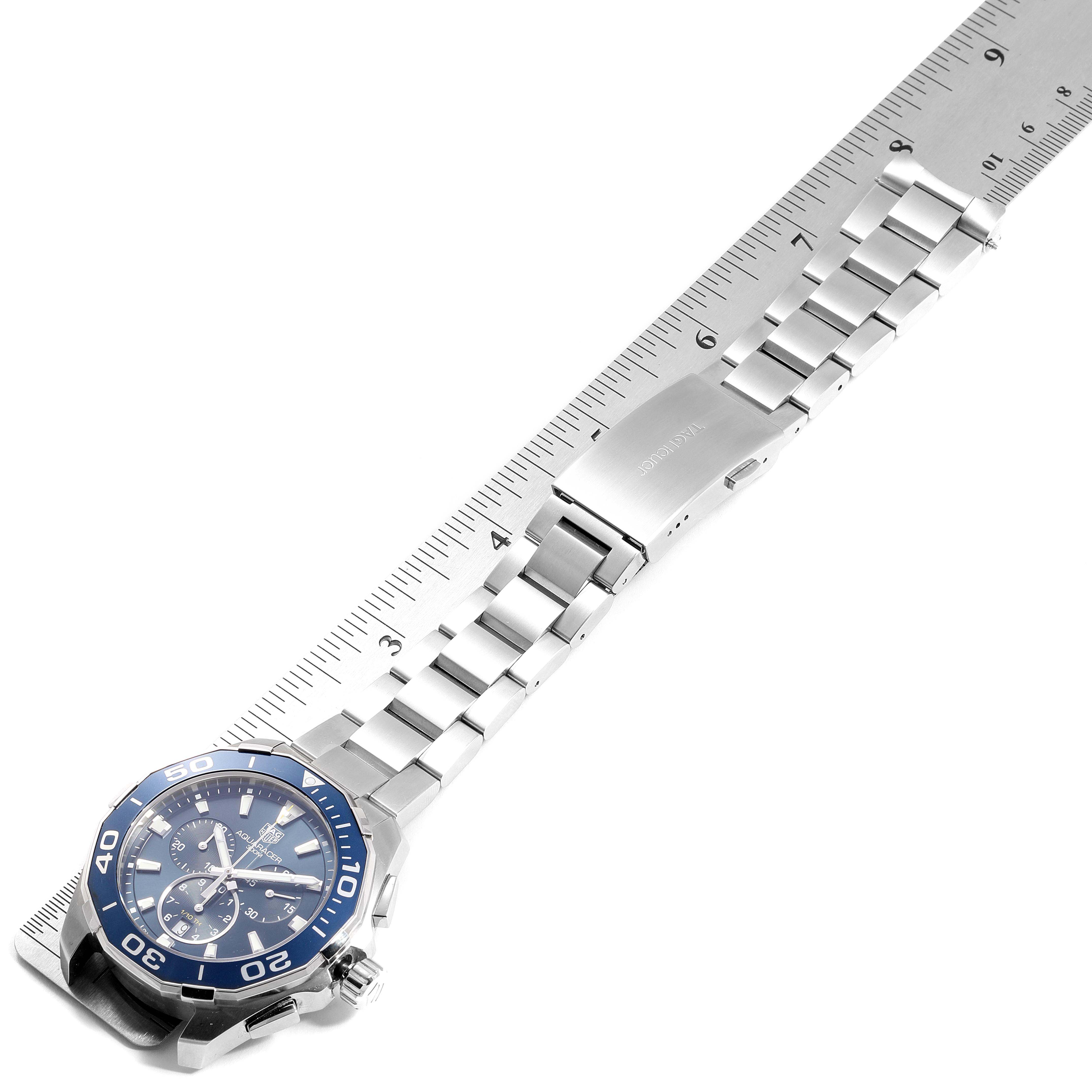 The Tag Heuer Aquaracer CAY111B.BA0927 Men
s Stainless Steel Blue Dial CAY111B.BA0927 Men
s Stainless Steel Blue Dial watch is displayed diagonally, showing its face, bezel, and stainless steel bracelet against a ruler.