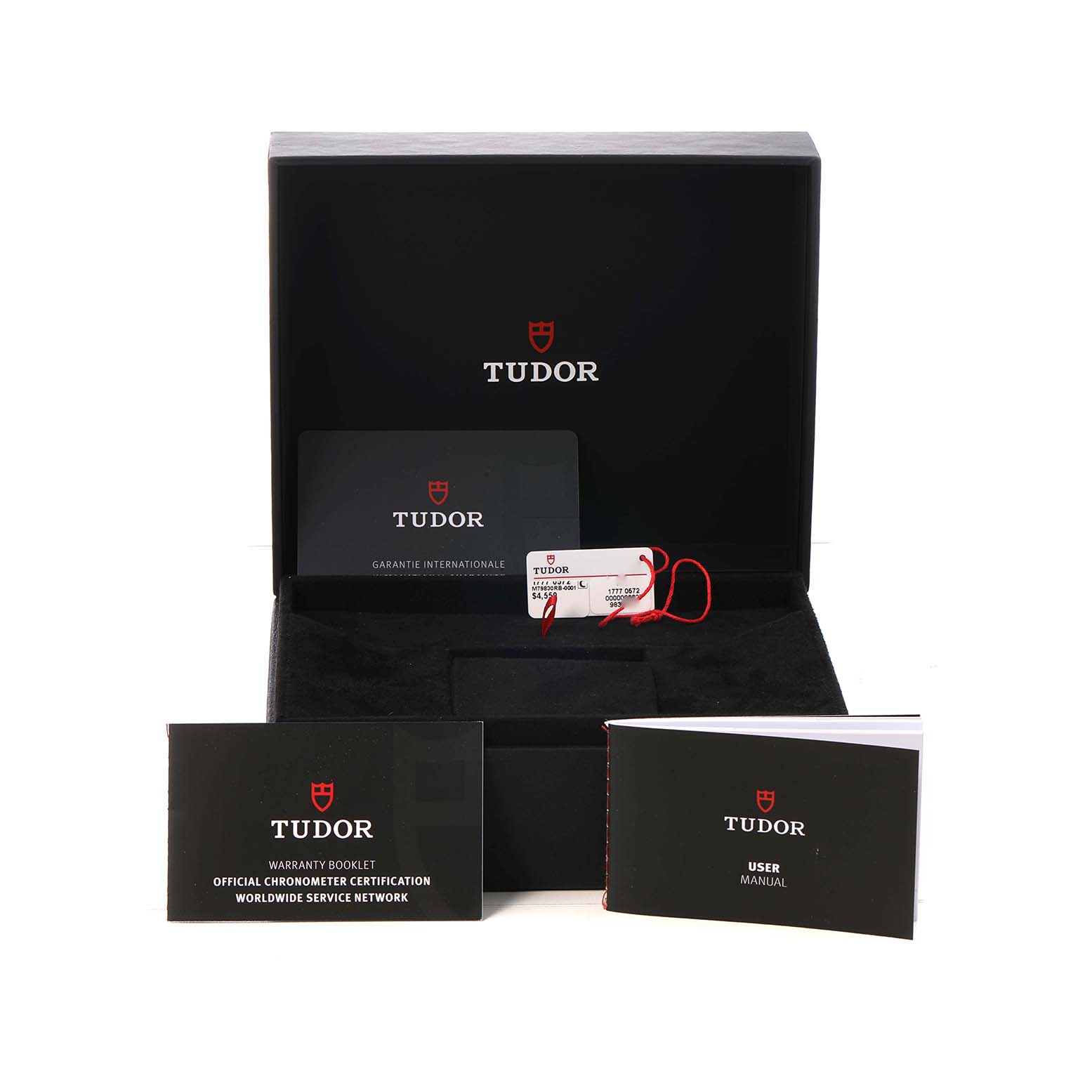 The image shows the Heritage Black Bay Tudor watch packaging with a box, warranty card, tags, and manuals displayed.
