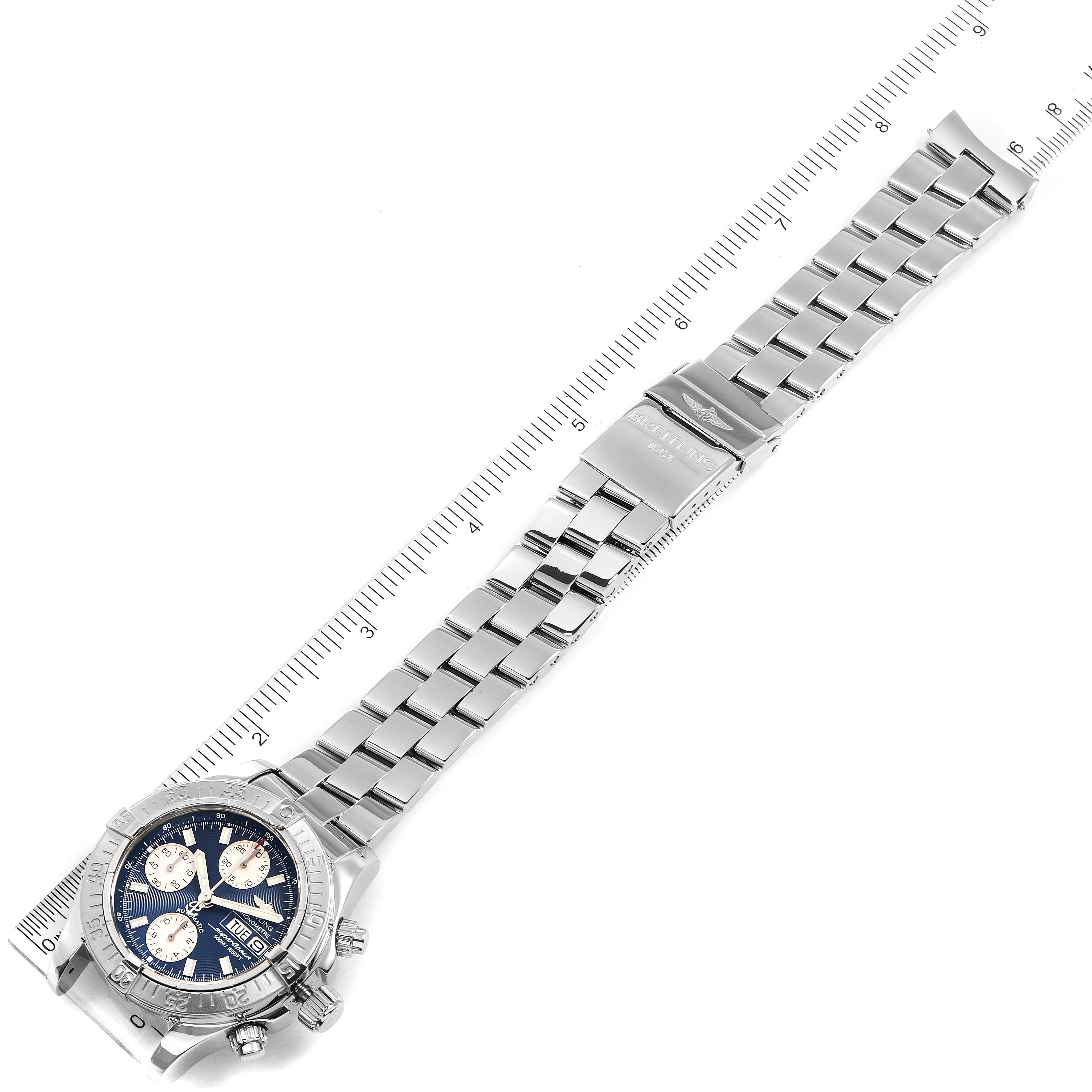The image shows the Breitling Superocean A13340 Men's Stainless Steel Blue Dial A13340 Men's Stainless Steel Blue Dial watch laid flat, displaying its face, bracelet, and clasp, angled diagonally across a ruler.