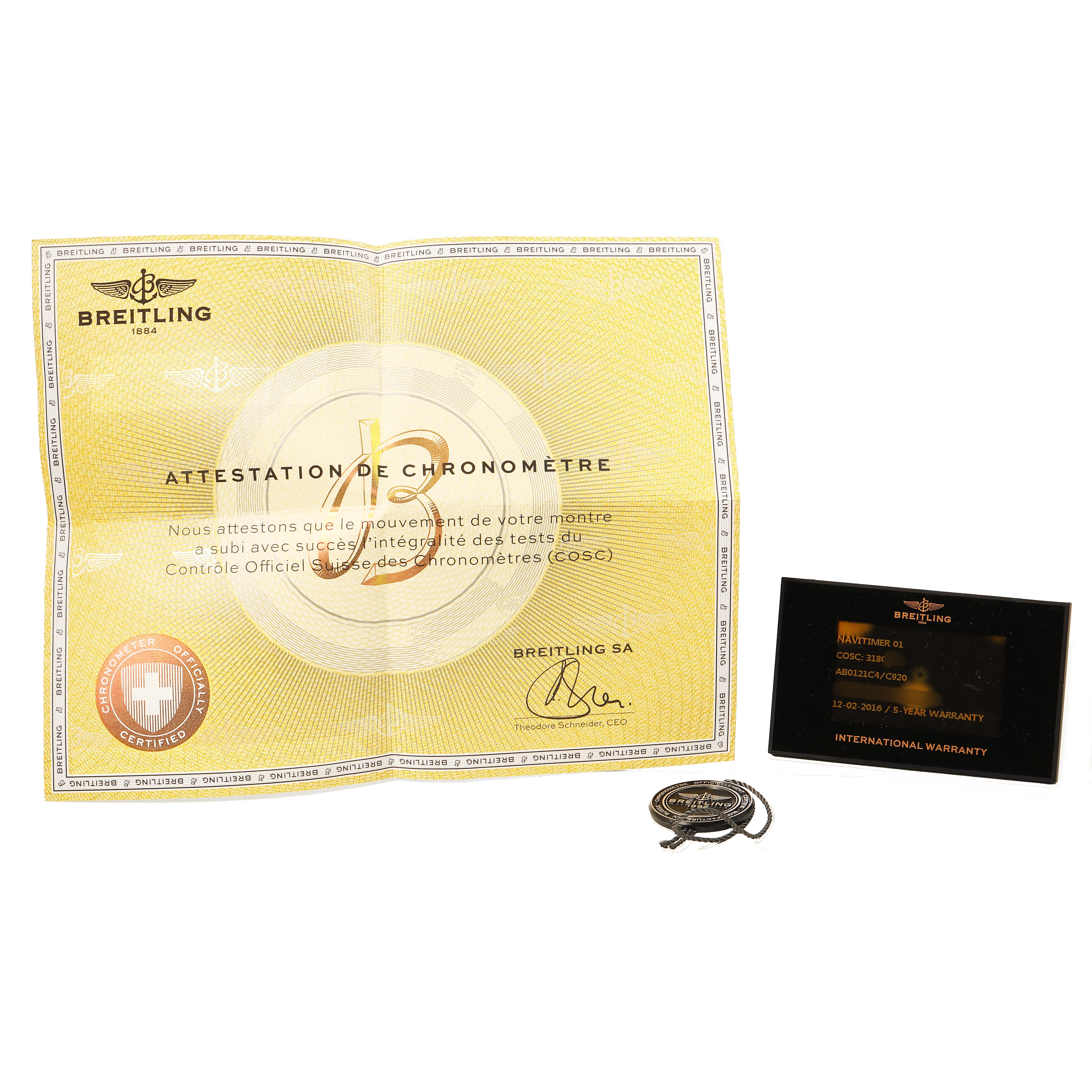 The image shows the Breitling Navitimer AB0121C4/C920 Men's Stainless Steel Blue Dial model's certificate, warranty card, and a tied tag, displayed from above.