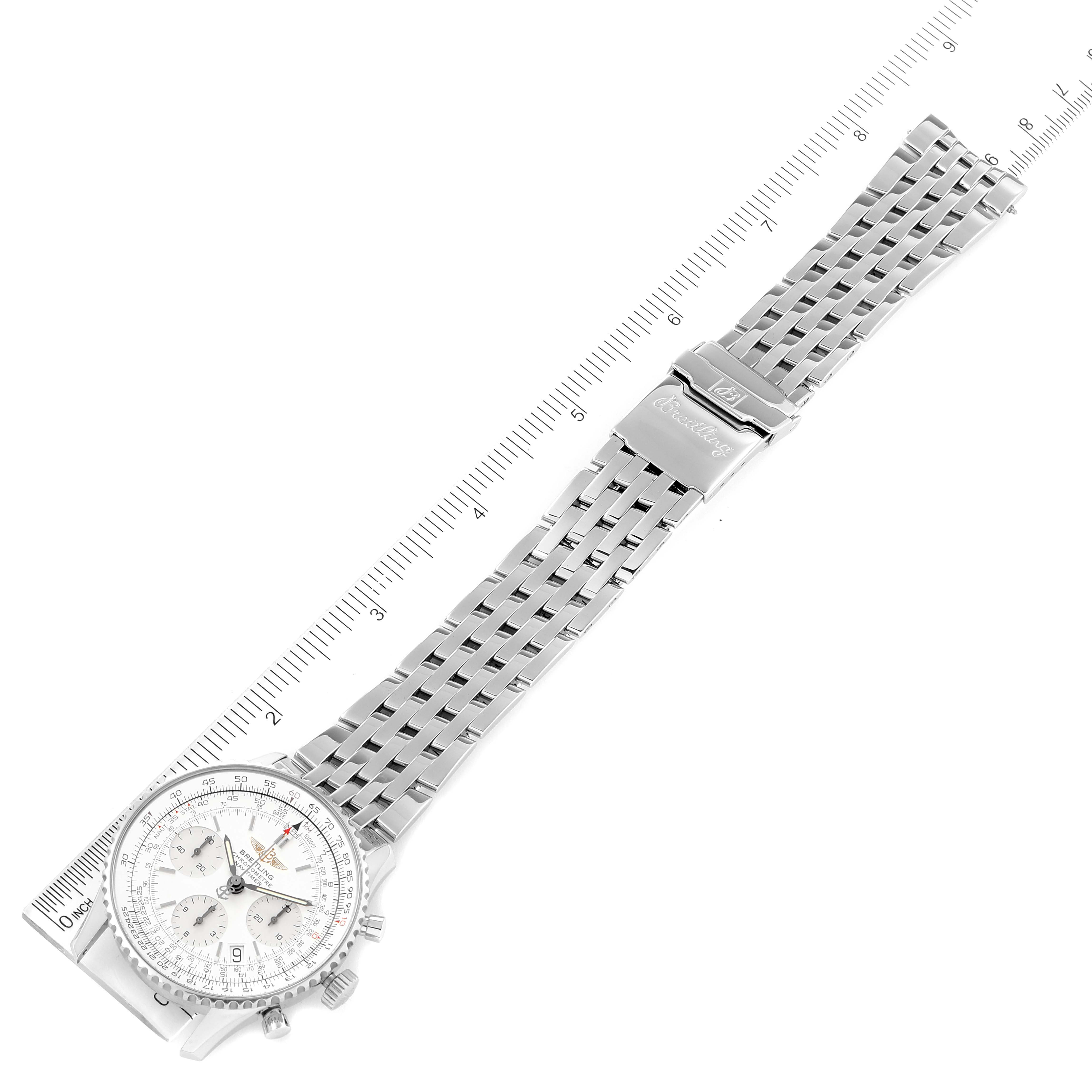 The image shows a Breitling Navitimer A23322 Men's Stainless Steel Silver Dial A23322 Men's Stainless Steel Silver Dial watch laid flat with its bracelet band extended next to a ruler for scale.