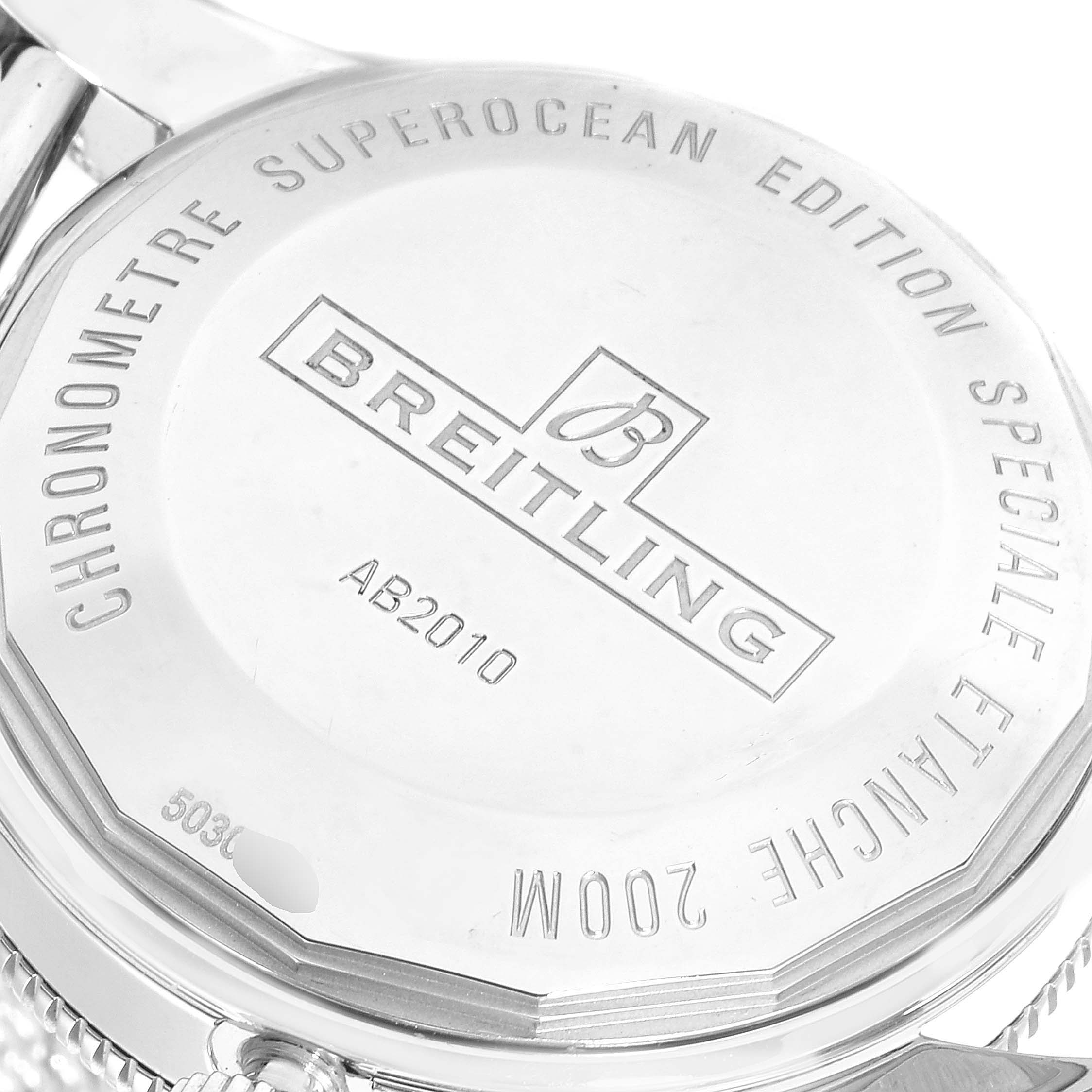This image shows the back casing of a Breitling Superocean AB2010161C1A1 Men's Stainless Steel Blue Dial AB2010161C1A1 Men's Stainless Steel Blue Dial watch, highlighting the engraved details and logo.