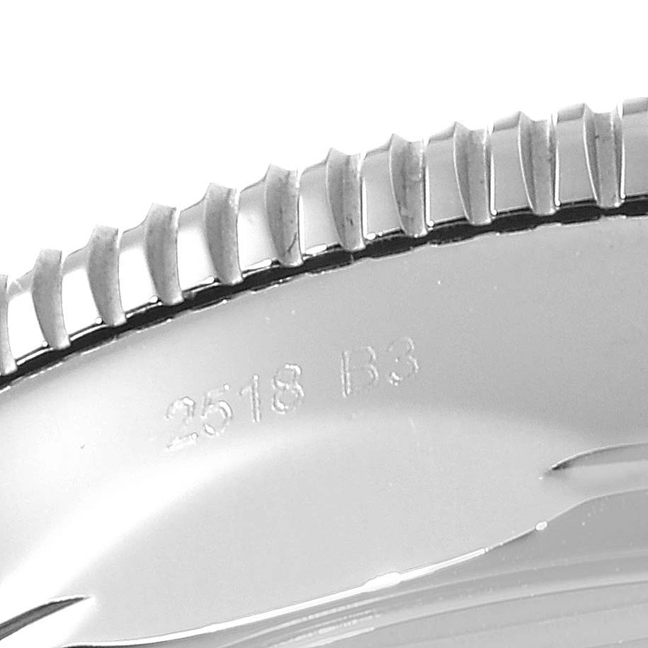 This is a close-up shot of the bezel edge and case back of the Breitling Superocean AB2010161C1A1 Men's Stainless Steel Blue Dial AB2010161C1A1 Men's Stainless Steel Blue Dial watch, showing texture and inscription.