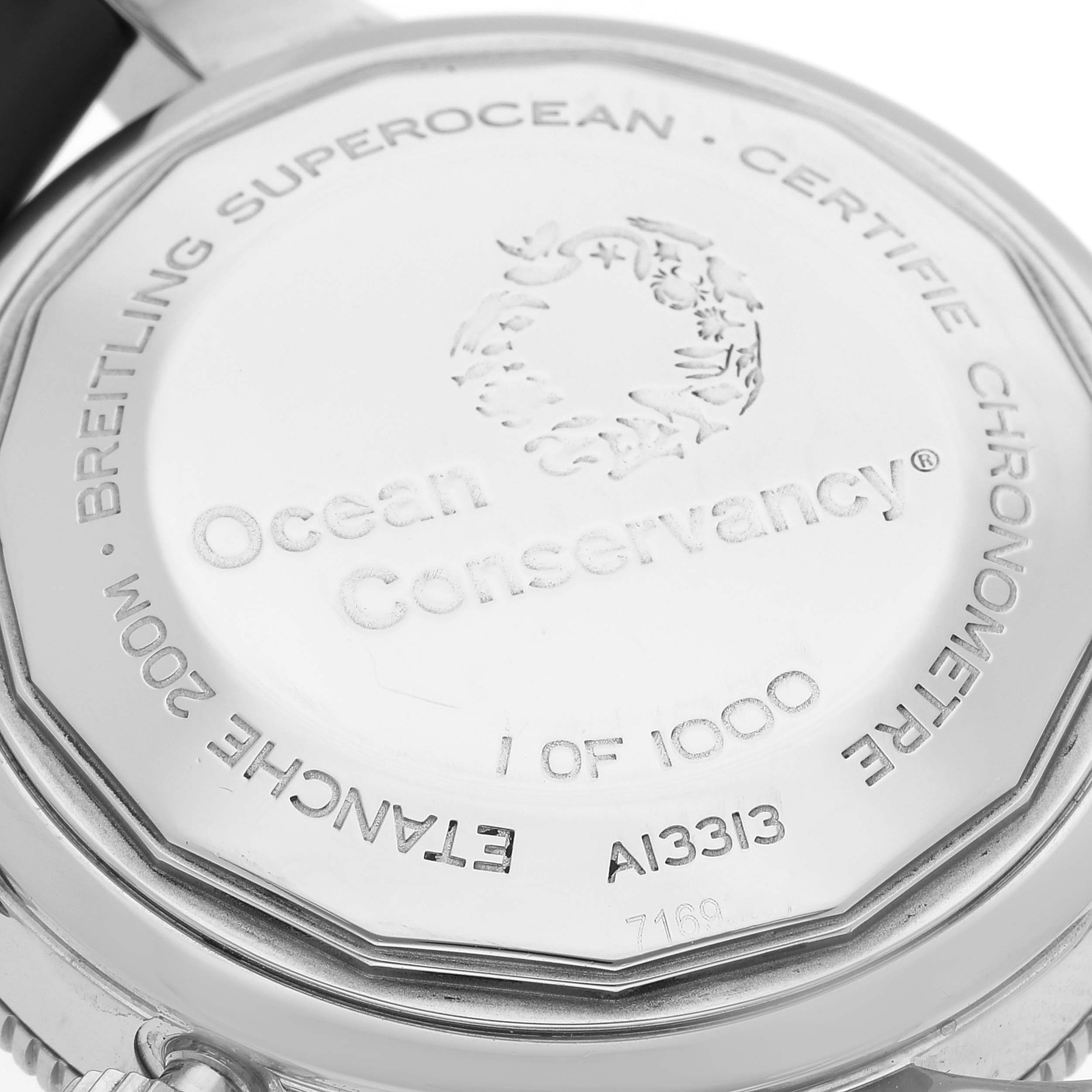 The image shows the case back of a Breitling Superocean A13313 Men's Stainless Steel Silver Dial A13313 Men's Stainless Steel Silver Dial watch, highlighting the "Ocean Conservancy" engraving.