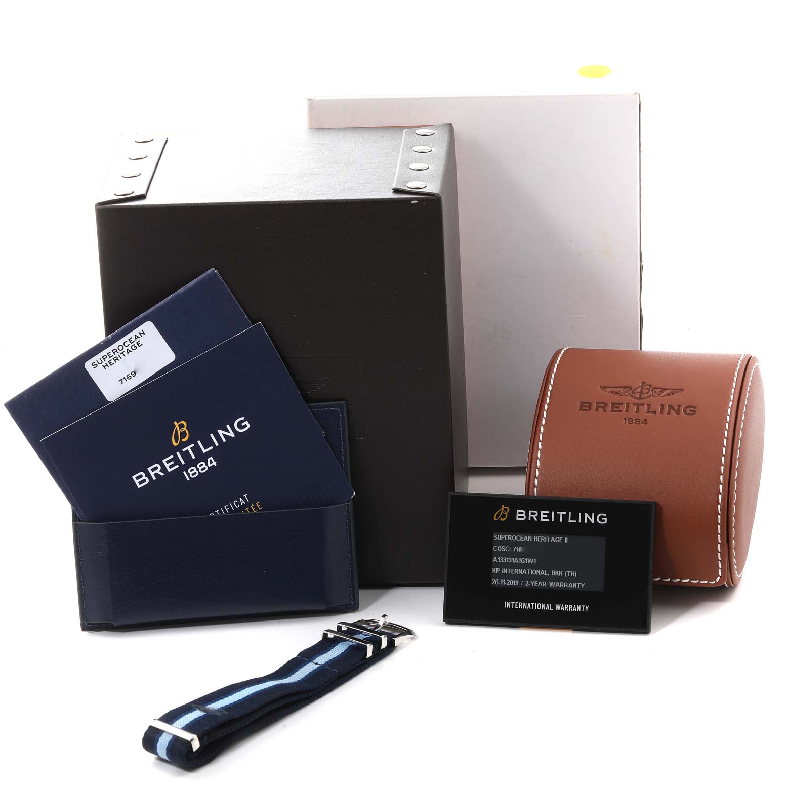 The image shows the Breitling Superocean A13313 Men's Stainless Steel Silver Dial A13313 Men's Stainless Steel Silver Dial watch packaging, including warranty cards, a leather case, a strap, and boxes.