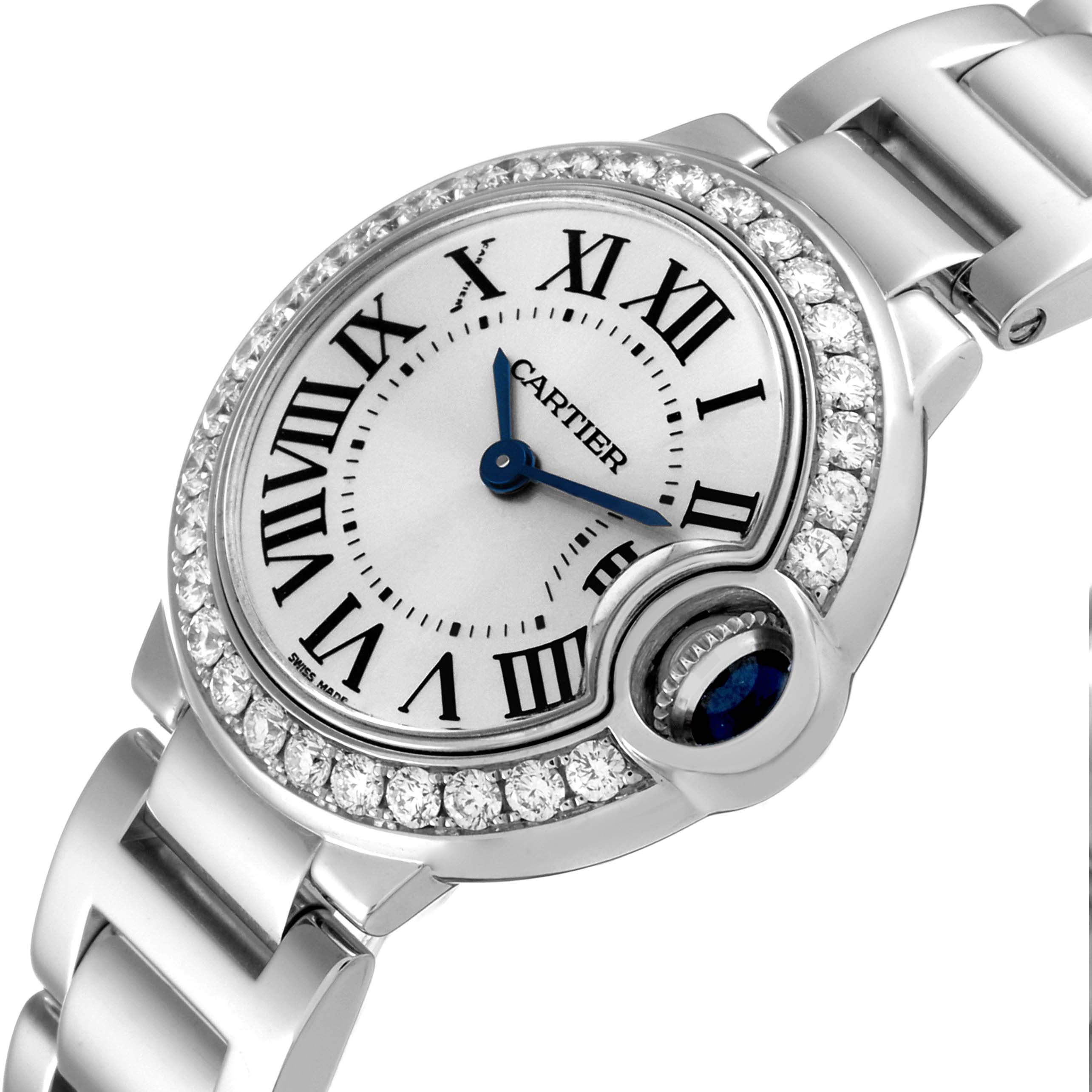 This image shows a close-up, angled view of the Cartier Ballon Bleu WE9003Z3 Women's White Gold Silver Dial WE9003Z3 Women's White Gold Silver Dial watch face, highlighting its Roman numerals, diamond bezel, and metallic bracelet.