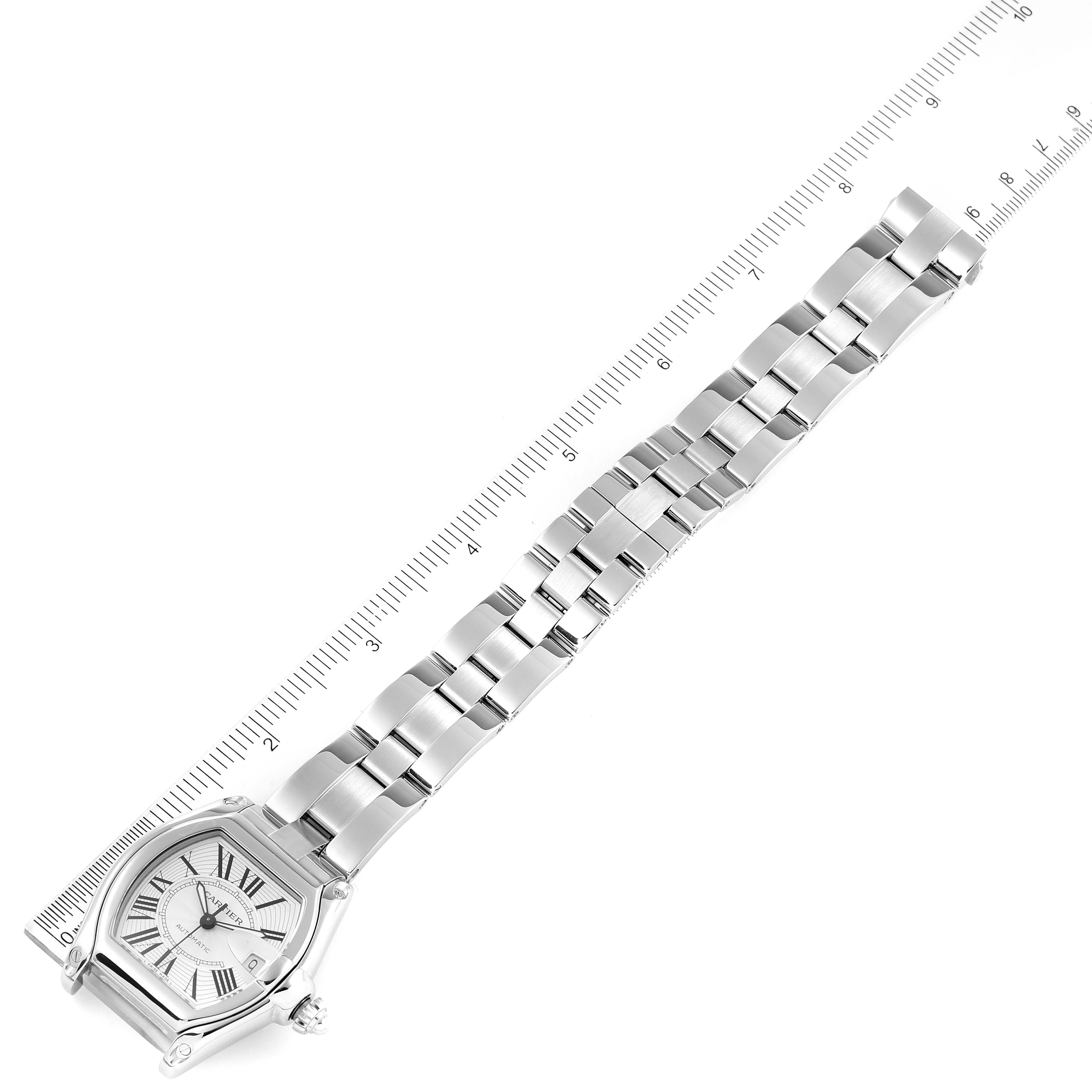 The image shows the Cartier Roadster W62025V3 Men's Stainless Steel Silver Dial W62025V3 Men's Stainless Steel Silver Dial watch face and metal bracelet at a top-down angle alongside a ruler for scale.