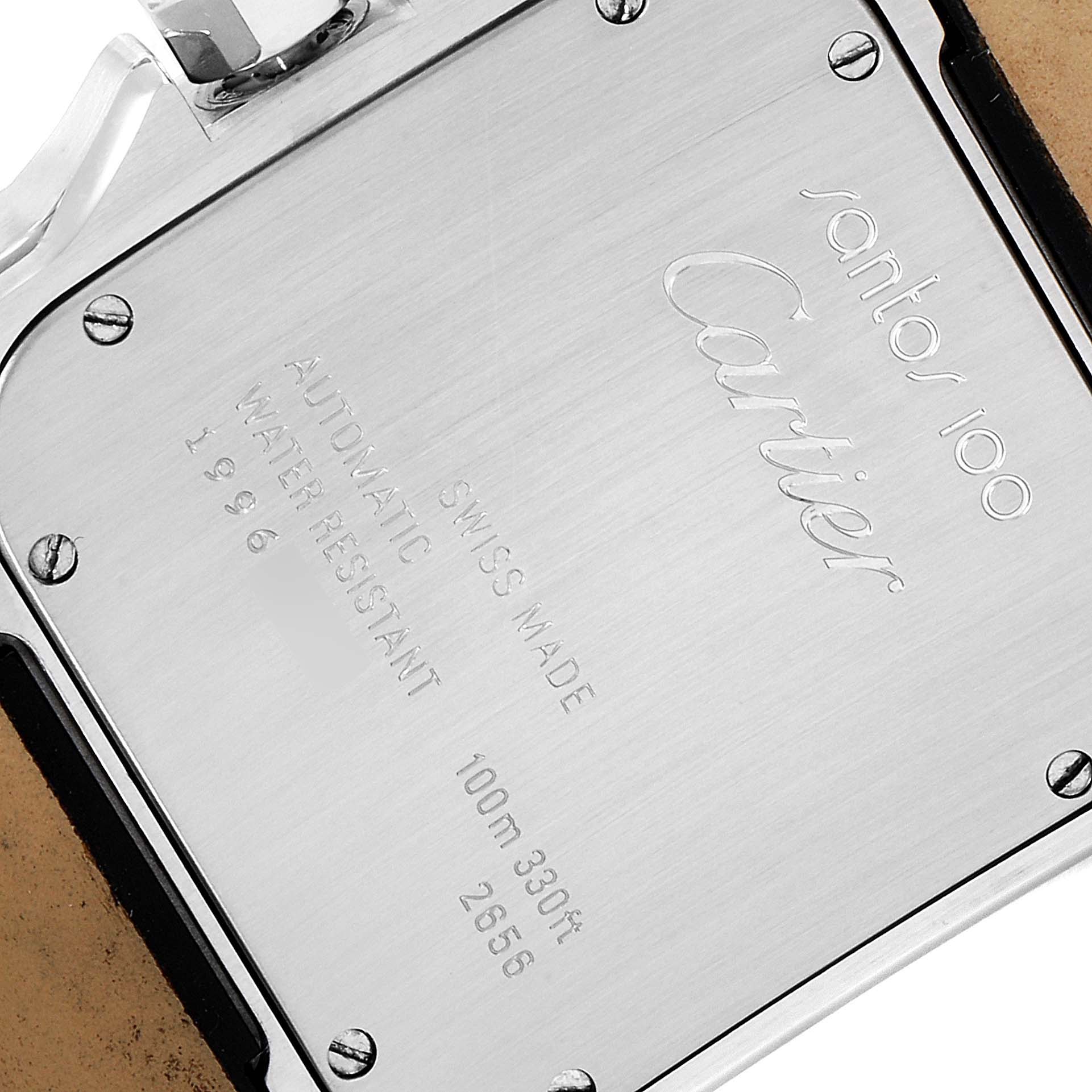 The image shows the backside of a Cartier Santos W20072X7 Men's Steel and Gold (two tone) Silver Dial W20072X7 Men's Steel and Gold (two tone) Silver Dial 100 watch, featuring engravings and screws.